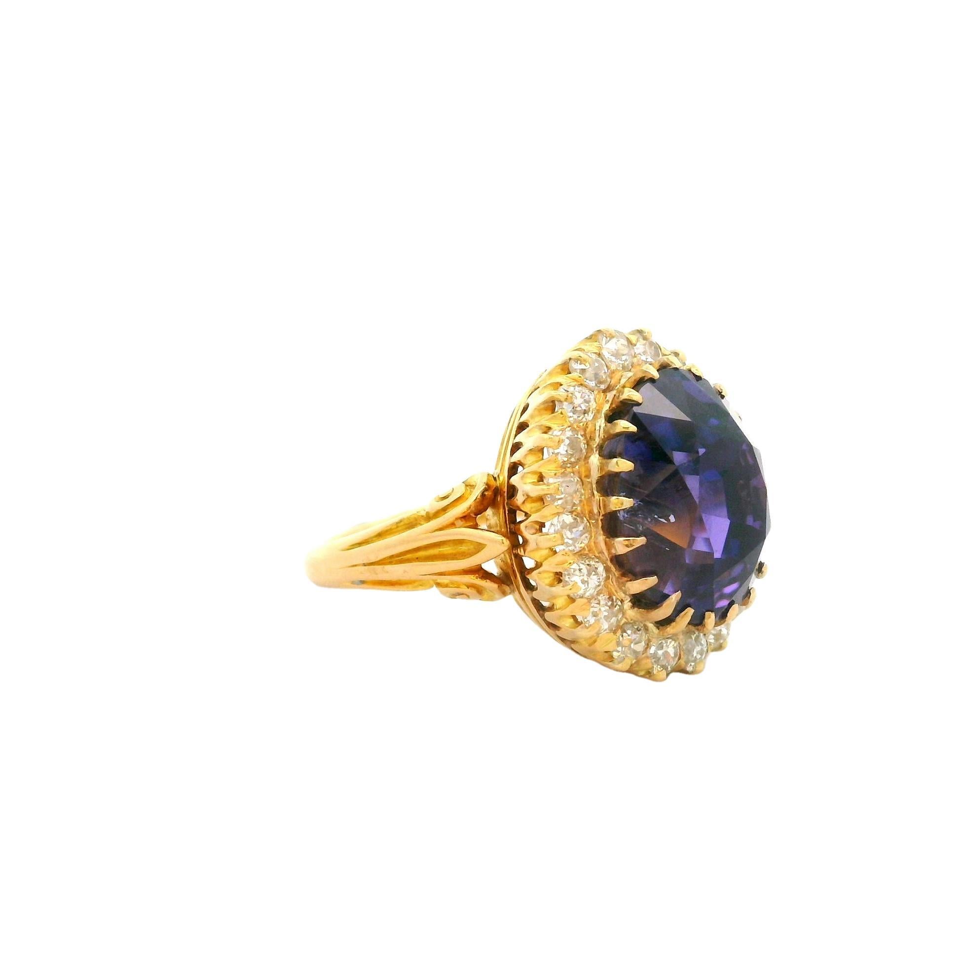 An exquisite color change sapphire, weighing an impressive 13.86 carats, is the centerpiece of this revived Victorian ring. The sapphire, cut in an elegant oval shape, displays an exquisite over the top full color change going from a rich royal