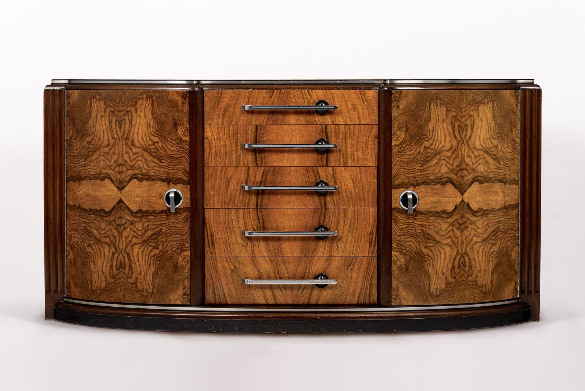 This exceptional antique Art Deco burl wood sideboard buffet credenza or bar cabinet is circa 1940. The cabinet is expertly hand-crafted from walnut and gorgeous book-matched walnut burl wood veneer with metal banding detailing and beautiful