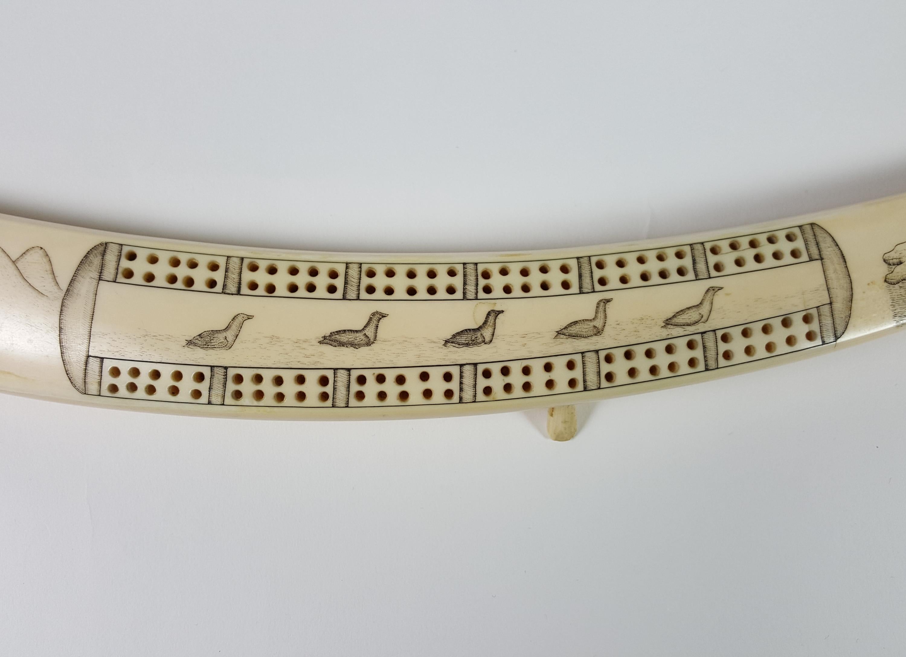 Really exceptional, antique, hand carved cribbage board. Carved from walrus tusk by a member of the Inuits, circa 1900.