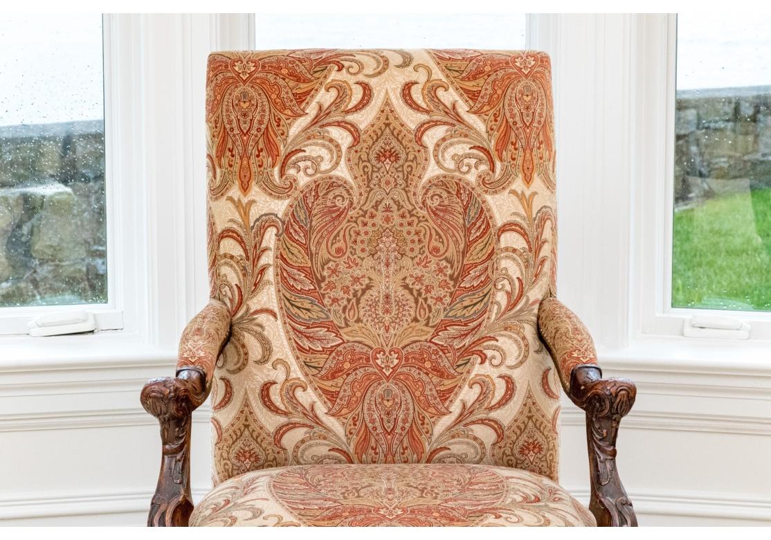 A very fine Antique Arm Chair with well carved frame dating into the 19th Century. The frame with strong foliate carving, the arms with an interesting re-curved support and the apron and cabriolet legs with more foliate carvings and a stylized hoof