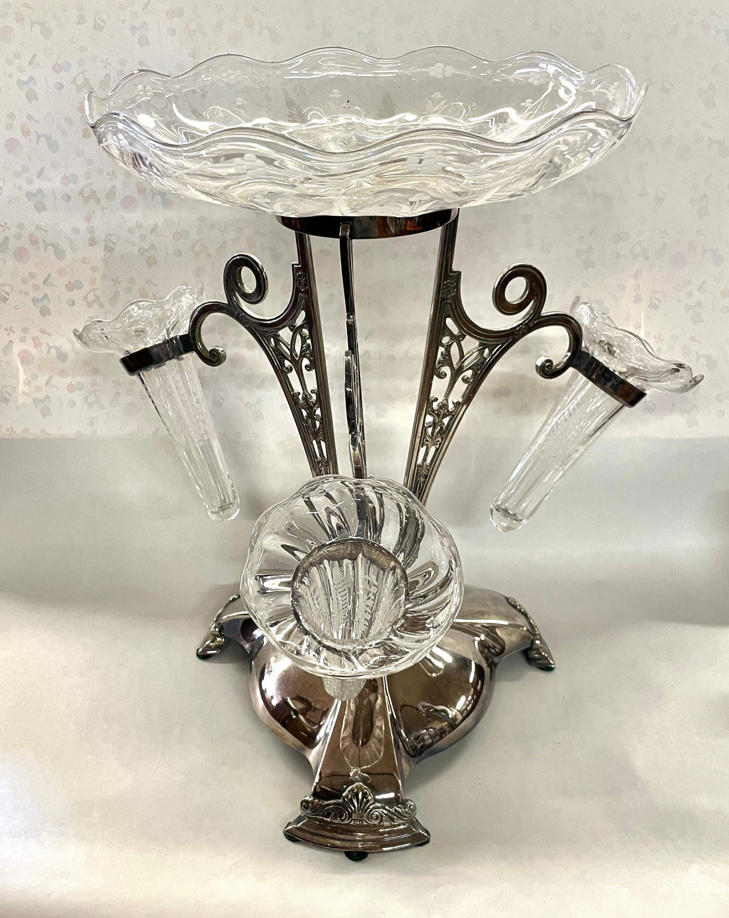An Extraordinary Large Size Antique English Sheffield Silver Plate and Hand Engraved Crystal Epergne Centerpiece with maker's marks under the base for the highly collected Royal Warranted silversmiths, Walker & Hall (Sheffield and London).  The