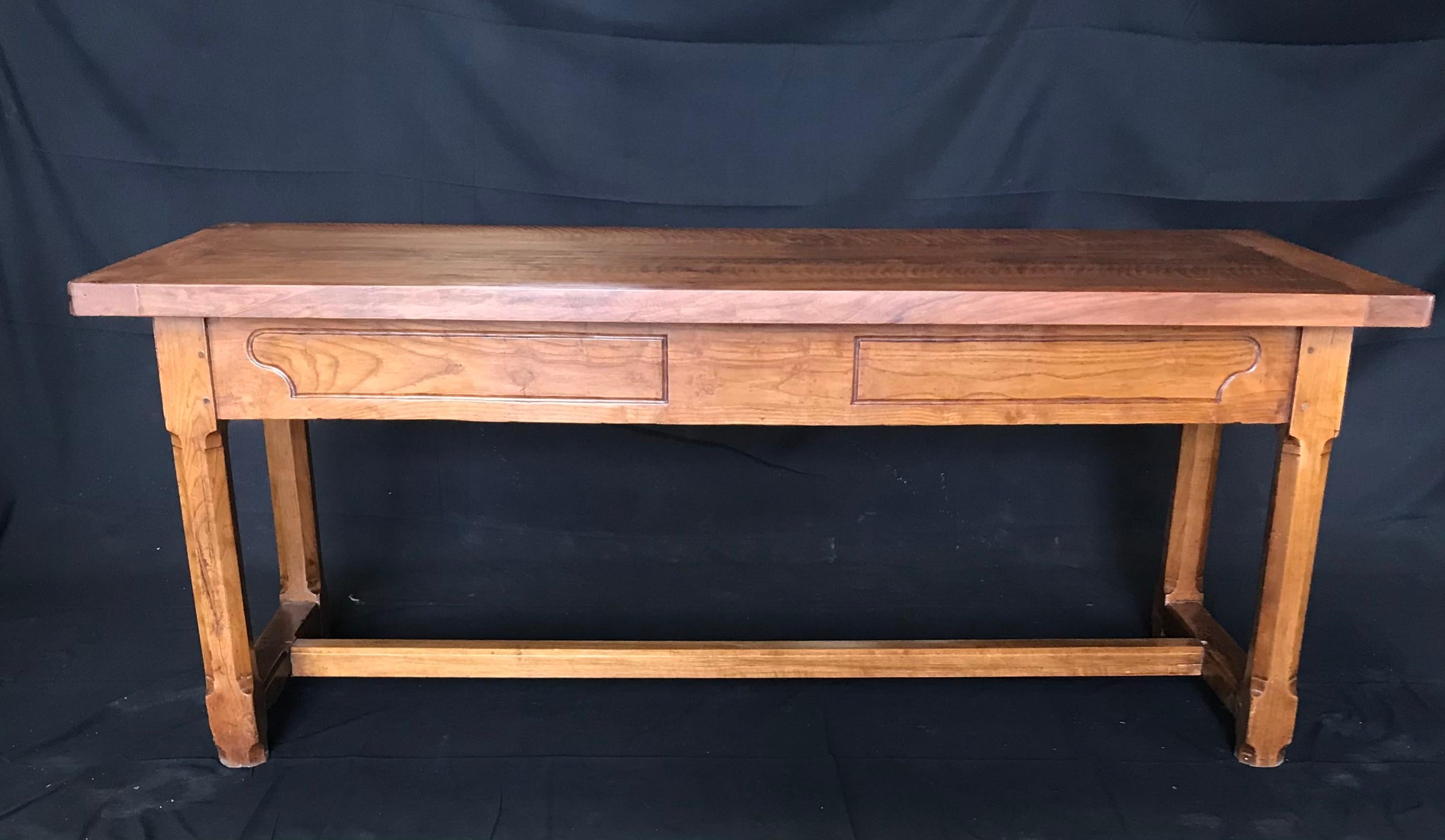An uncommonly fine traditional antique cherry French farm dining table with bread board top and center drawer with sliding side drawers that provide maximum storage. Carved square legs under beveled apron, exposed peg construction, all sides and