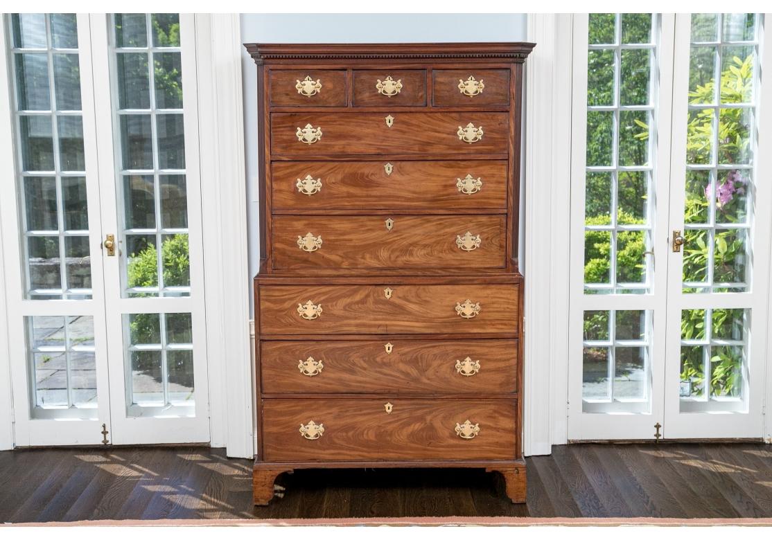 An impressive and very well made Antique English Georgian Chest-On-Chest with fine traditional form and handsome chosen wood. The Chest is large and has sizable Brass Batwing pulls and Key Escutcheons, canted and fluted front corners, Dentil