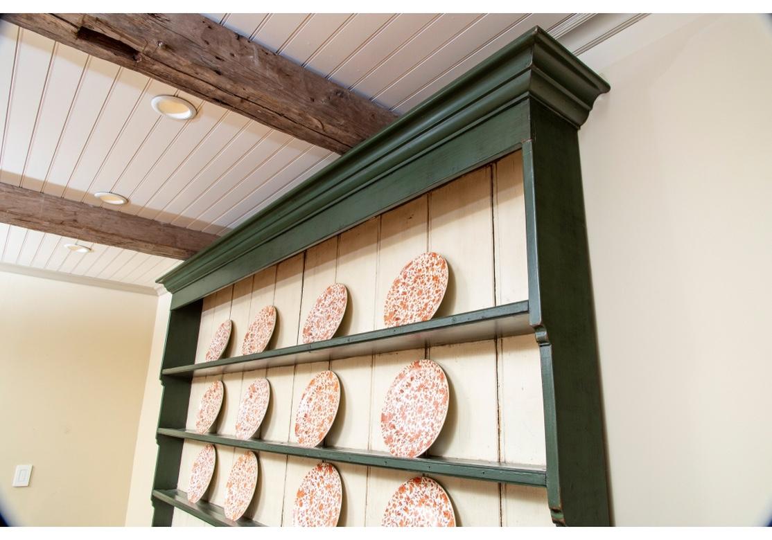 A large and truly fine authentic Hutch with original deep green paint, handsome brass bale pulls and excellent open style to display and store crockery and sundries. Originally sourced from The Yellow Monkey, Cross River, New York. Note: The plates