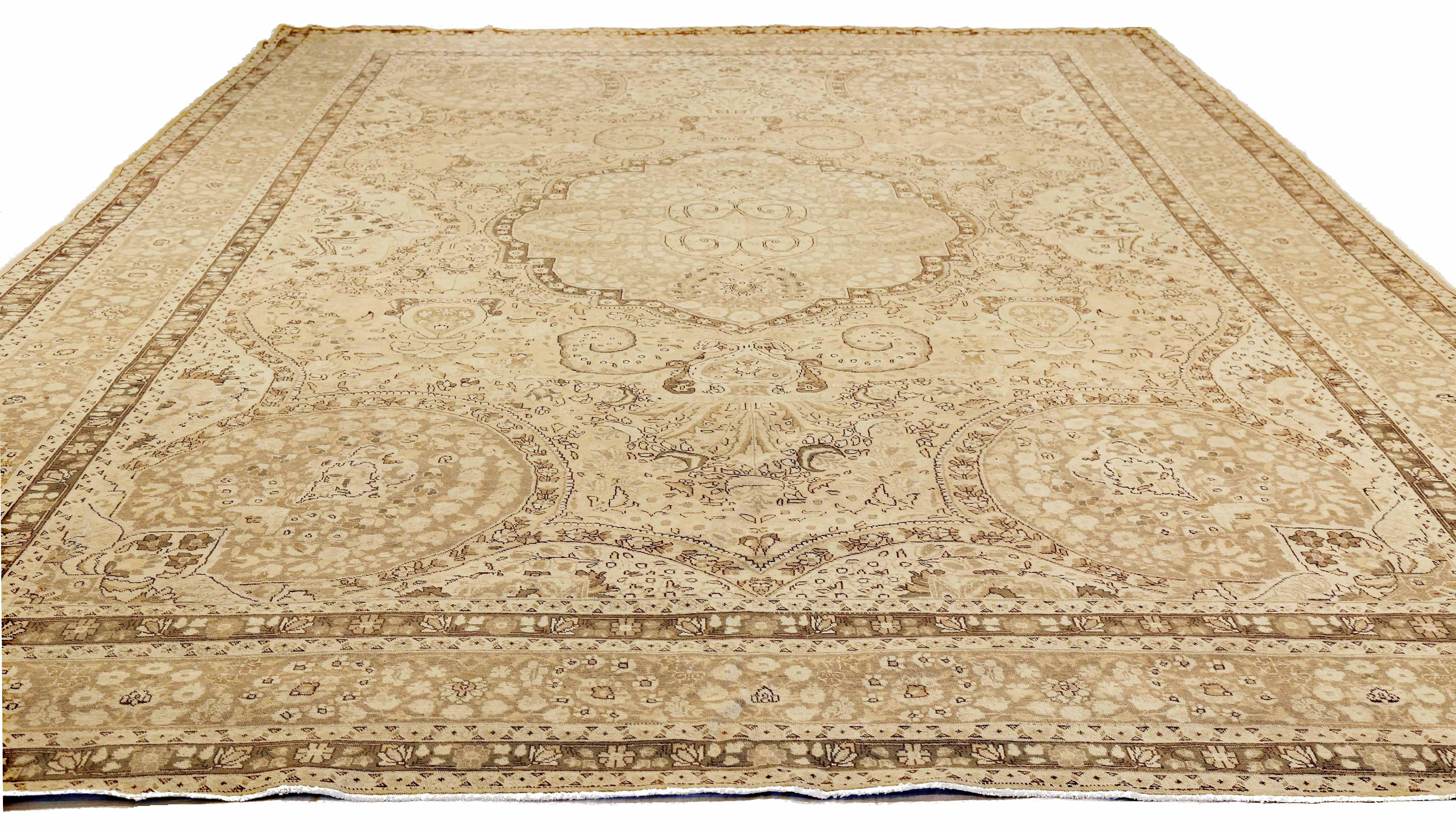 Antique Persian rug handwoven from the finest sheep’s wool and colored with all-natural vegetable dyes that are safe for humans and pets. It’s a traditional Tabriz weaving featuring a lovely ensemble of Fine floral designs in brown and black over a