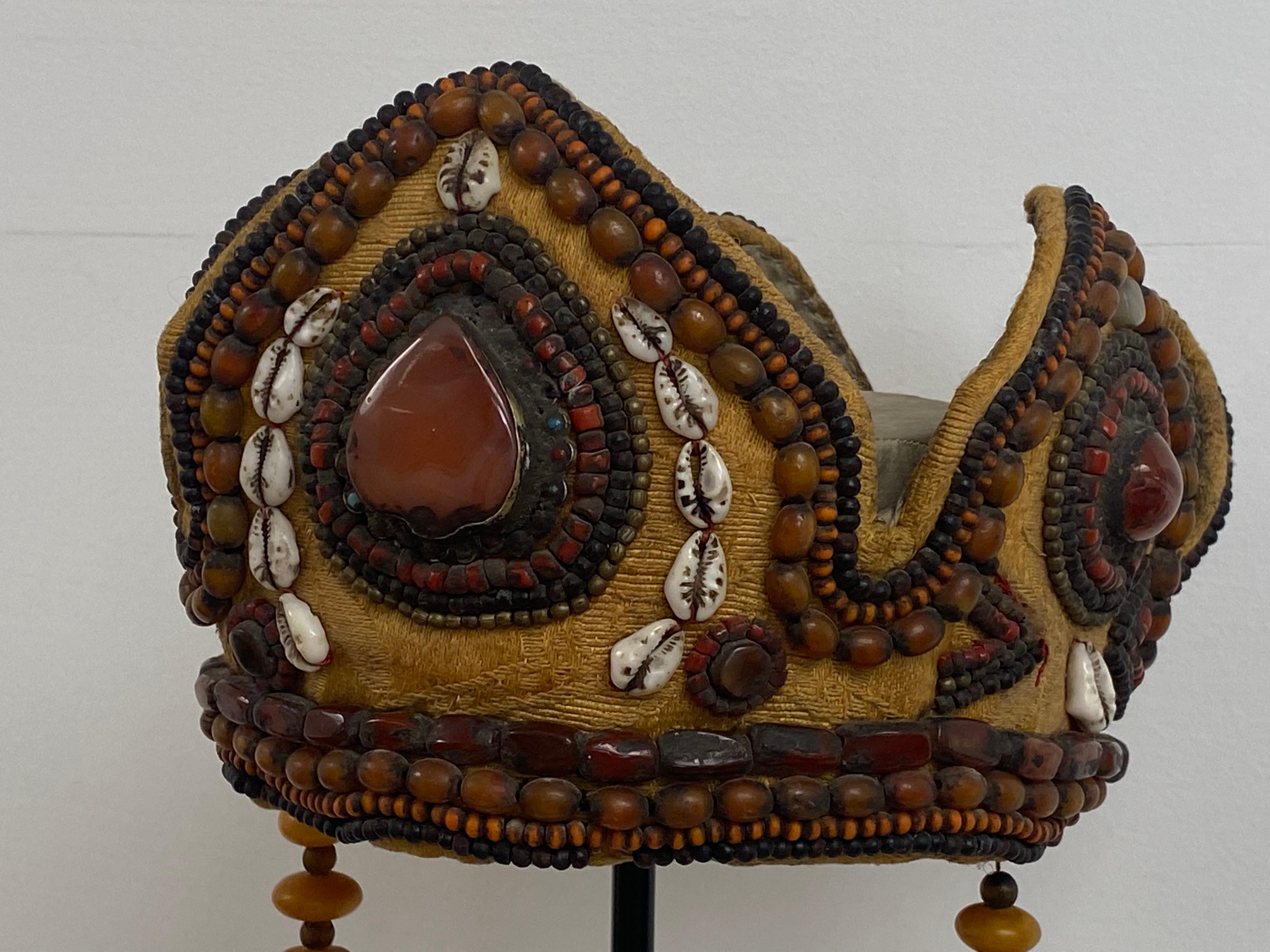 Exceptional Tibetan Parure made a Ceremonial Crown and a Ceremonial Necklace,from around 1920,
beautiful Royal Yellow color,
the Parure is in a good condition and has a great old patina,
beautifully decorated with old shells and antique beads and