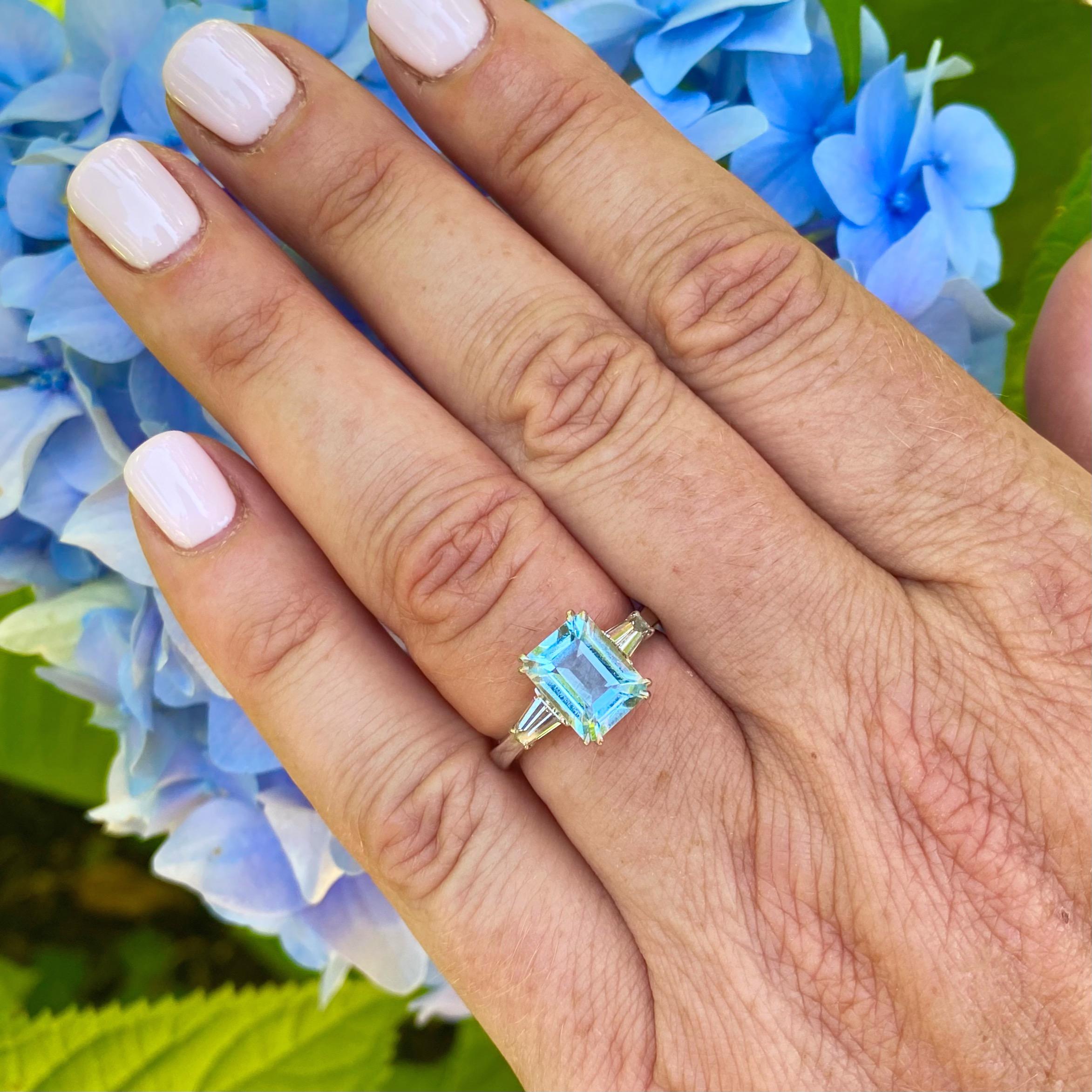 A truly gorgeous and timeless piece of jewelry. This 18 karat white gold piece features an fabulous 3.00 carat aquamarine with beautiful light return and a lovely soft blue color. The rectangular cut aqua is flanked by a perfectly matched pair of