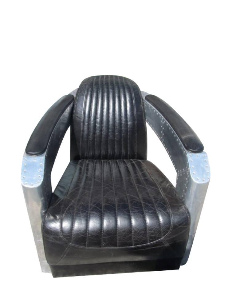 This extraordinary armchair is made of laminated aluminum and visible screws. It was made in fine craftmanship. The seat is made of black genuine leather and has a very good padding. A highlight for every apartment, as it is made in a very unusual