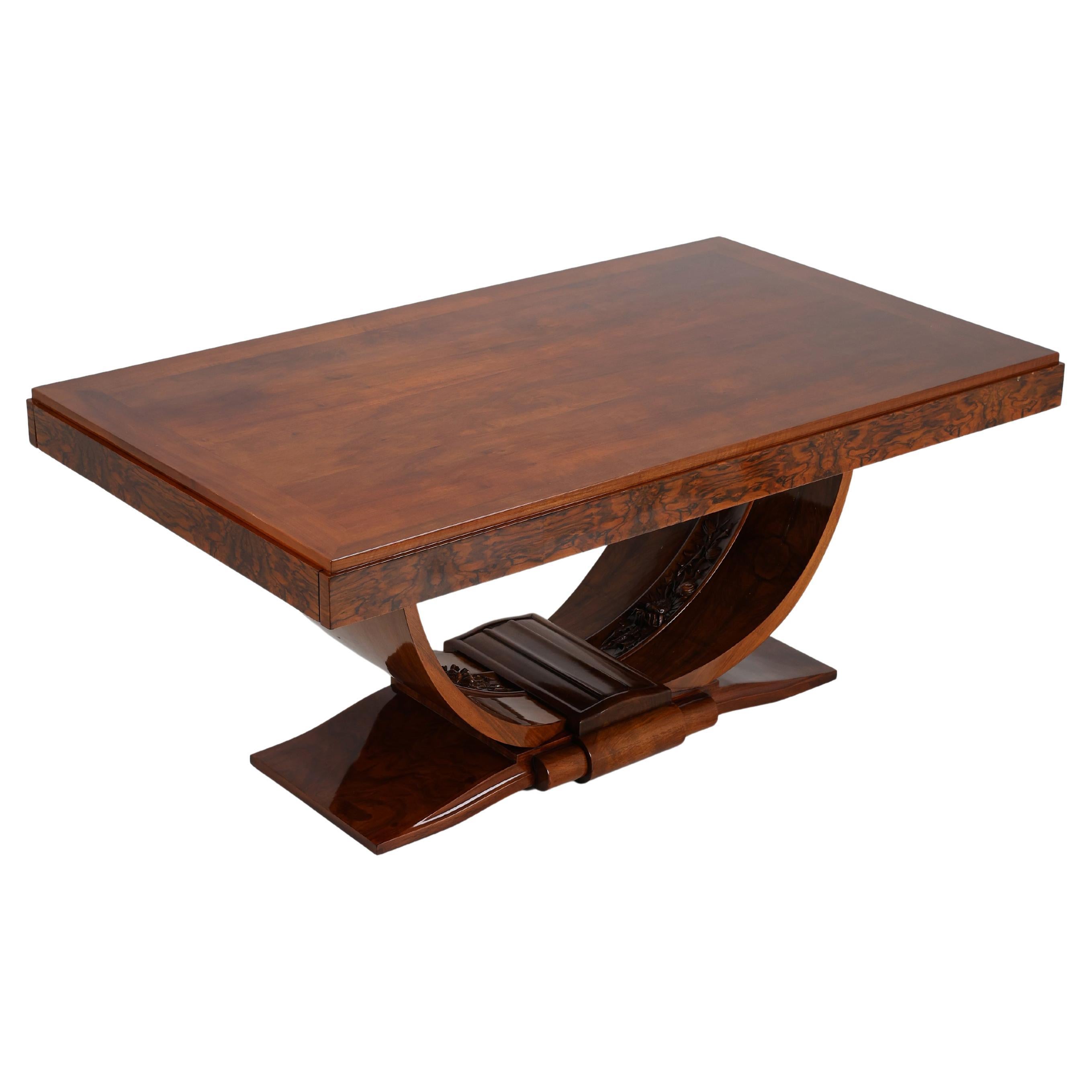 This exceptional Art Deco dining table, crafted from rich walnut wood, is a superb example of the period’s design and craftsmanship. The table extends to 2.2 metres with the addition of two finely made extension leaves, making it ideal for