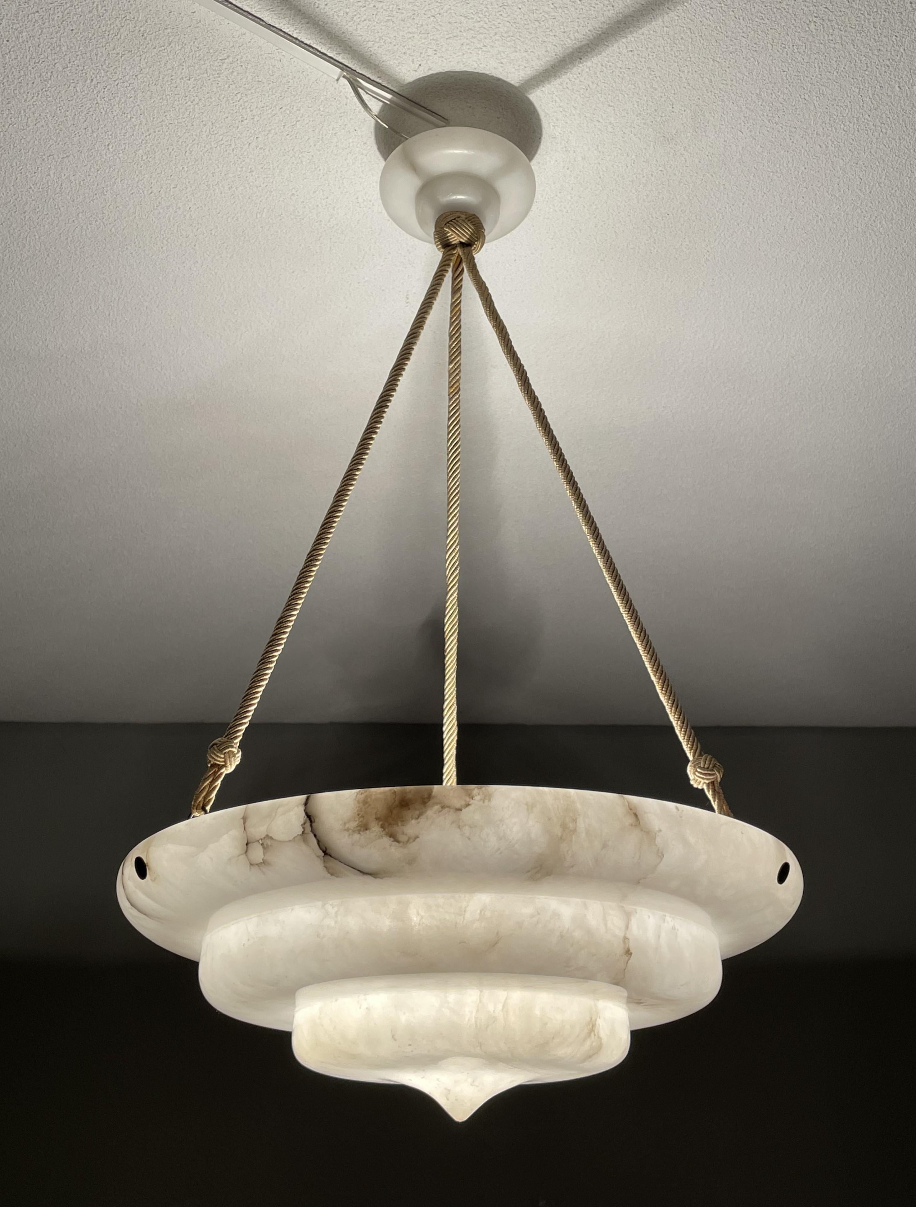 Stunning, geometrically circular Art Deco chandelier.

With early 20th century lighting as one of our specialities, we were thrilled to find another rare and truly beautiful Art Deco pendant, made of the most striking alabaster imaginable. The