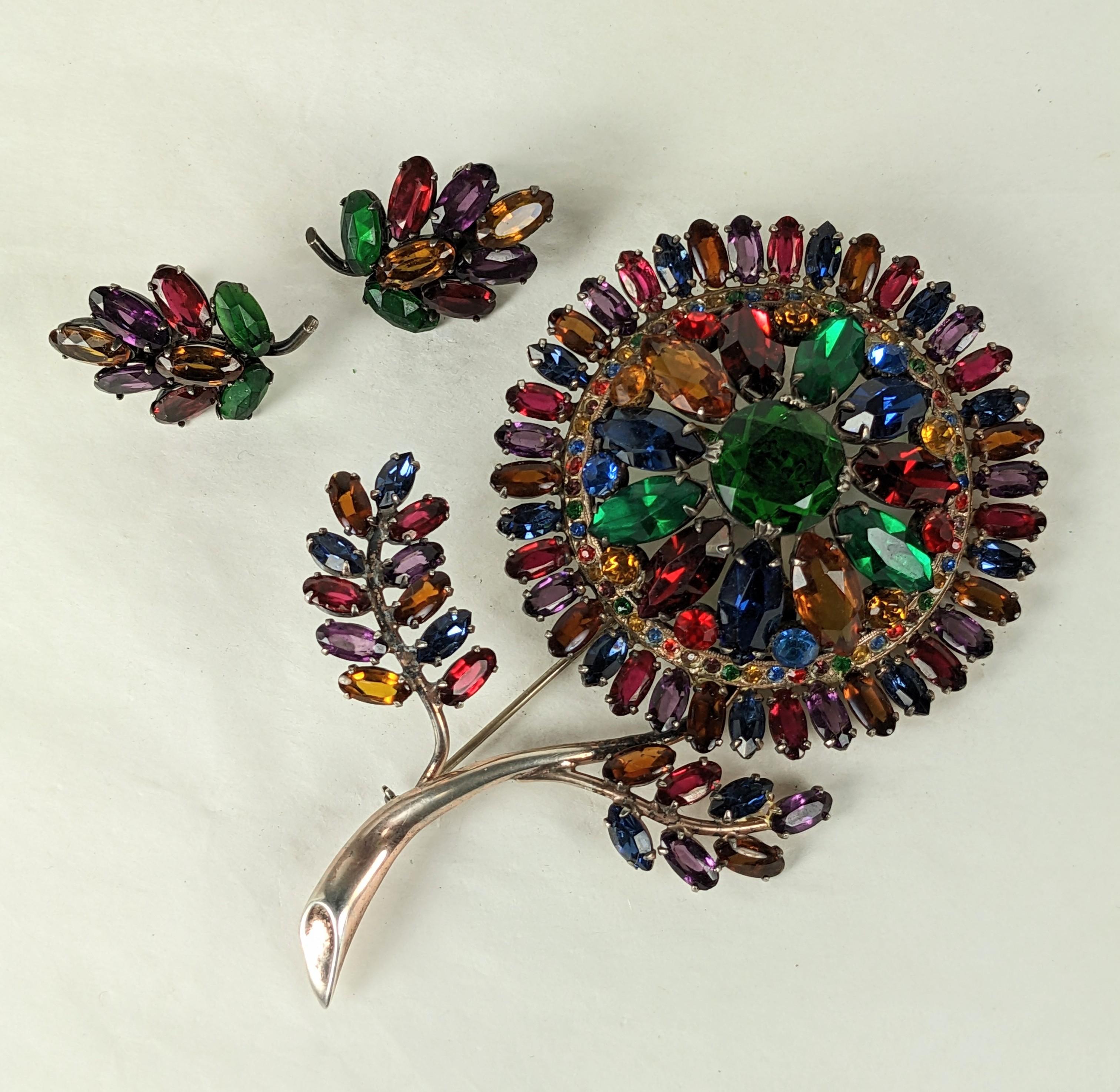 Exceptional Art Deco Jeweled Flower Set from the 1930's. Incredible scale and design in a multitude of colors set in sterling silver. Matching screw back earrings. 
1930's USA. Brooch 4.25