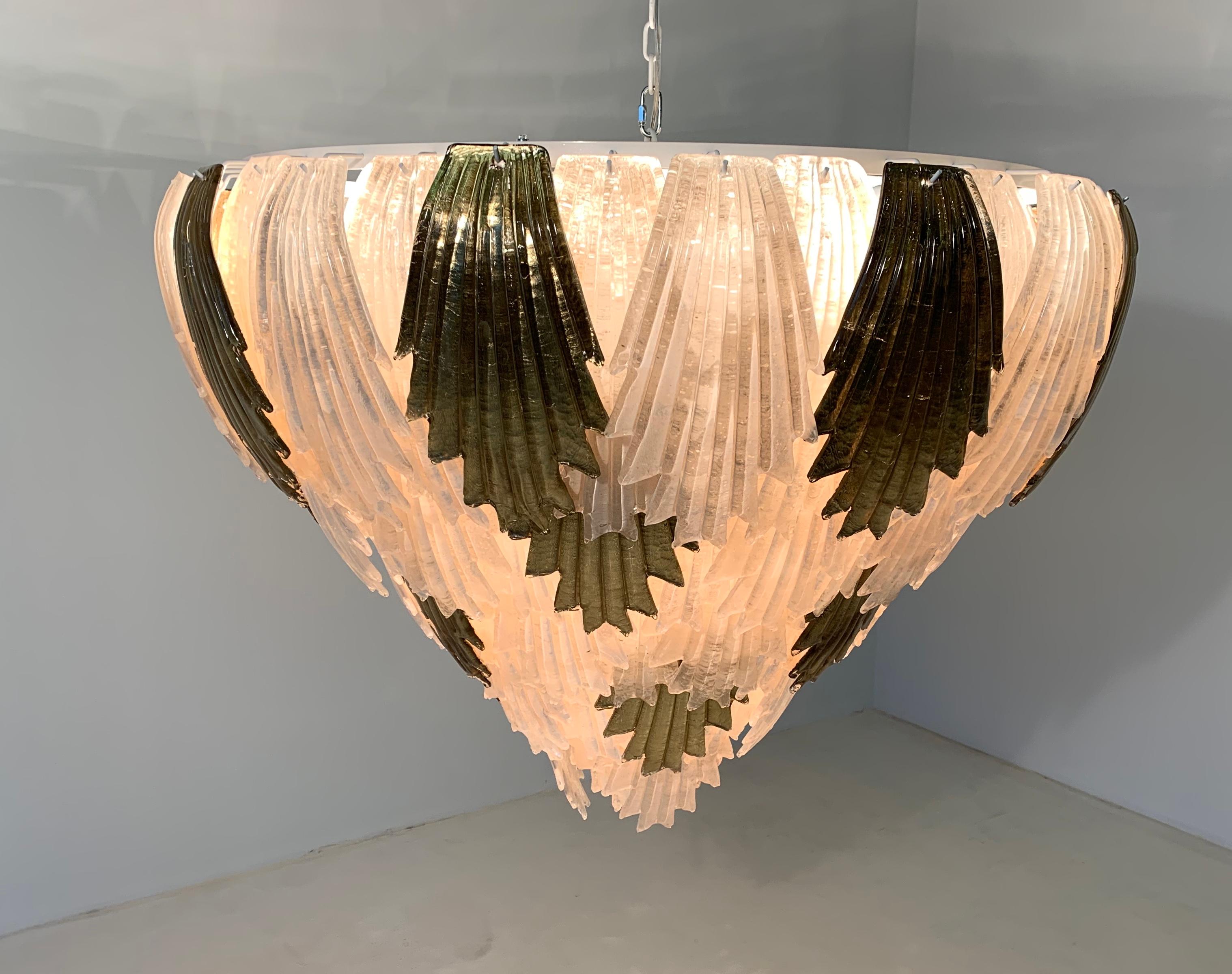 Stunning and large Murano glass chandelier formed by precious and important ivory and gold leaf glass leaves.
These fine pieces of glass are specially designed to create a warm and welcoming environment when lit.
This chandelier has been wired to