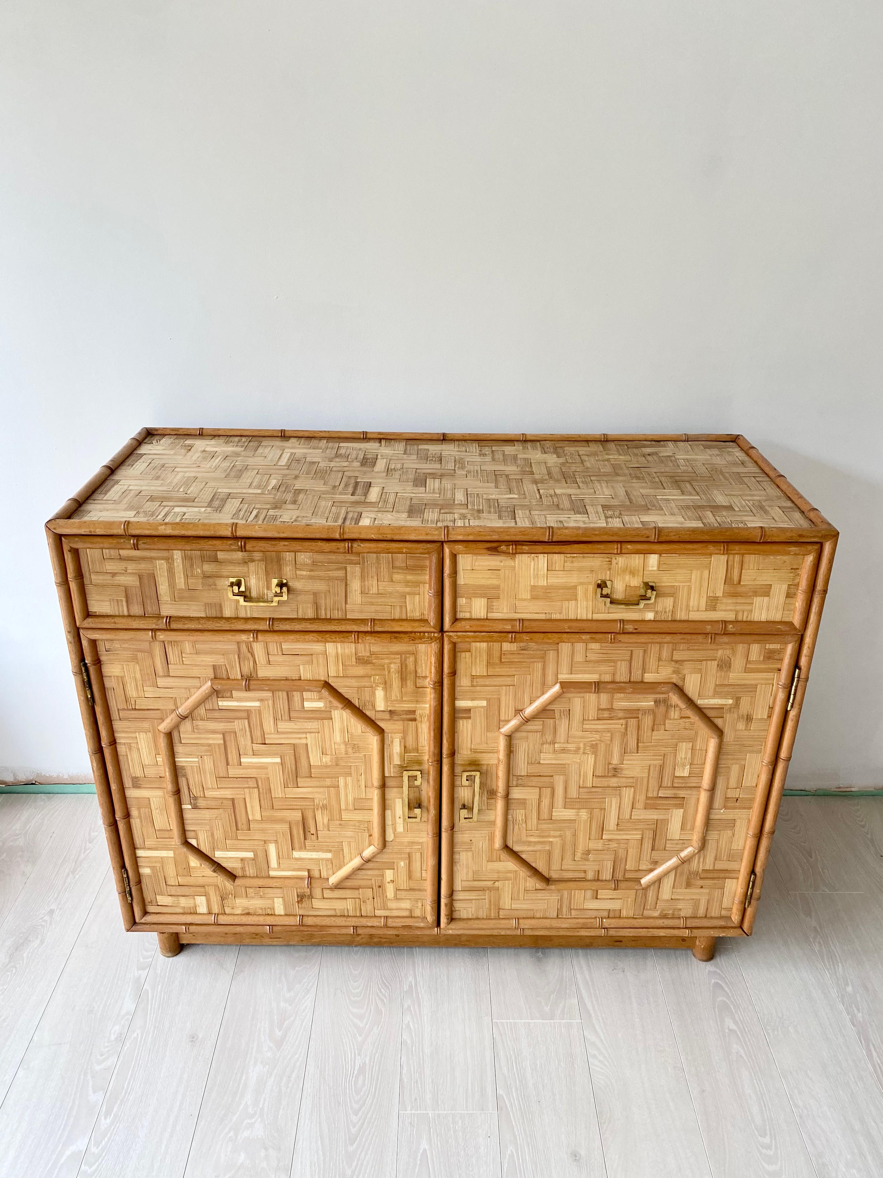 A midcentury rattan and bamboo sideboard.

In good vintage condition with aged brass handles.
Please note one top is slightly darker in colour than the other.

Measures: 114cm wide, 47cm deep, 90cm tall.

Pair available.