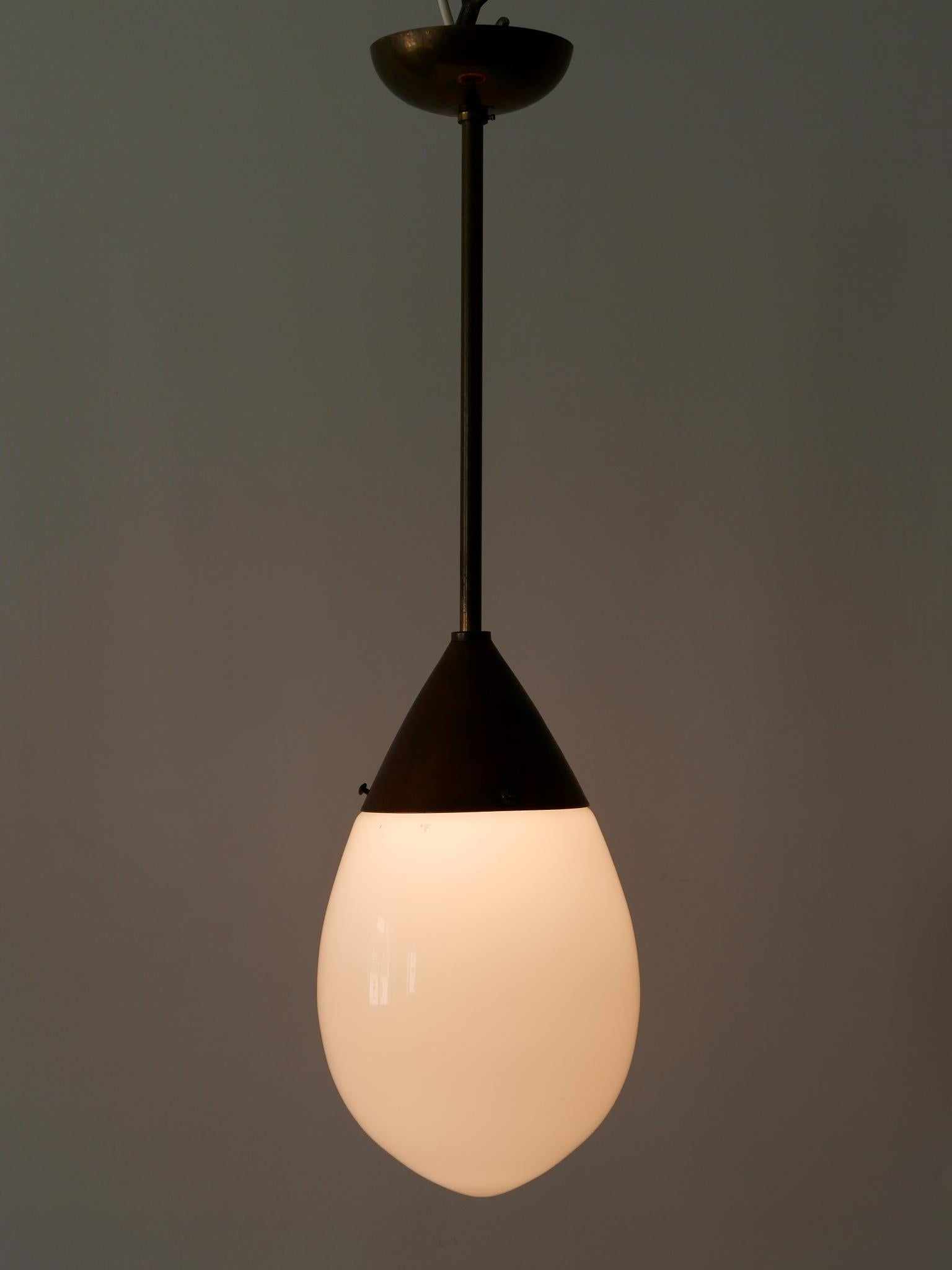 Extremely rare and minimalistic Bauhaus / modernist pendant lamp or hanging light 'Drop'. Designed probably by Peter Behrens for Siemens, 1920s, Germany.

Executed in copper, brass and opaline glass, the lamp needs 1 x E27 / E26 Edison screw fit