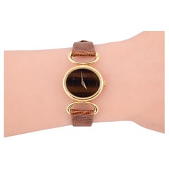 Exceptionnelle montre-bracelet Baume Mercier pour femmes avec cadran œil de tigre en or jaune 18 carats