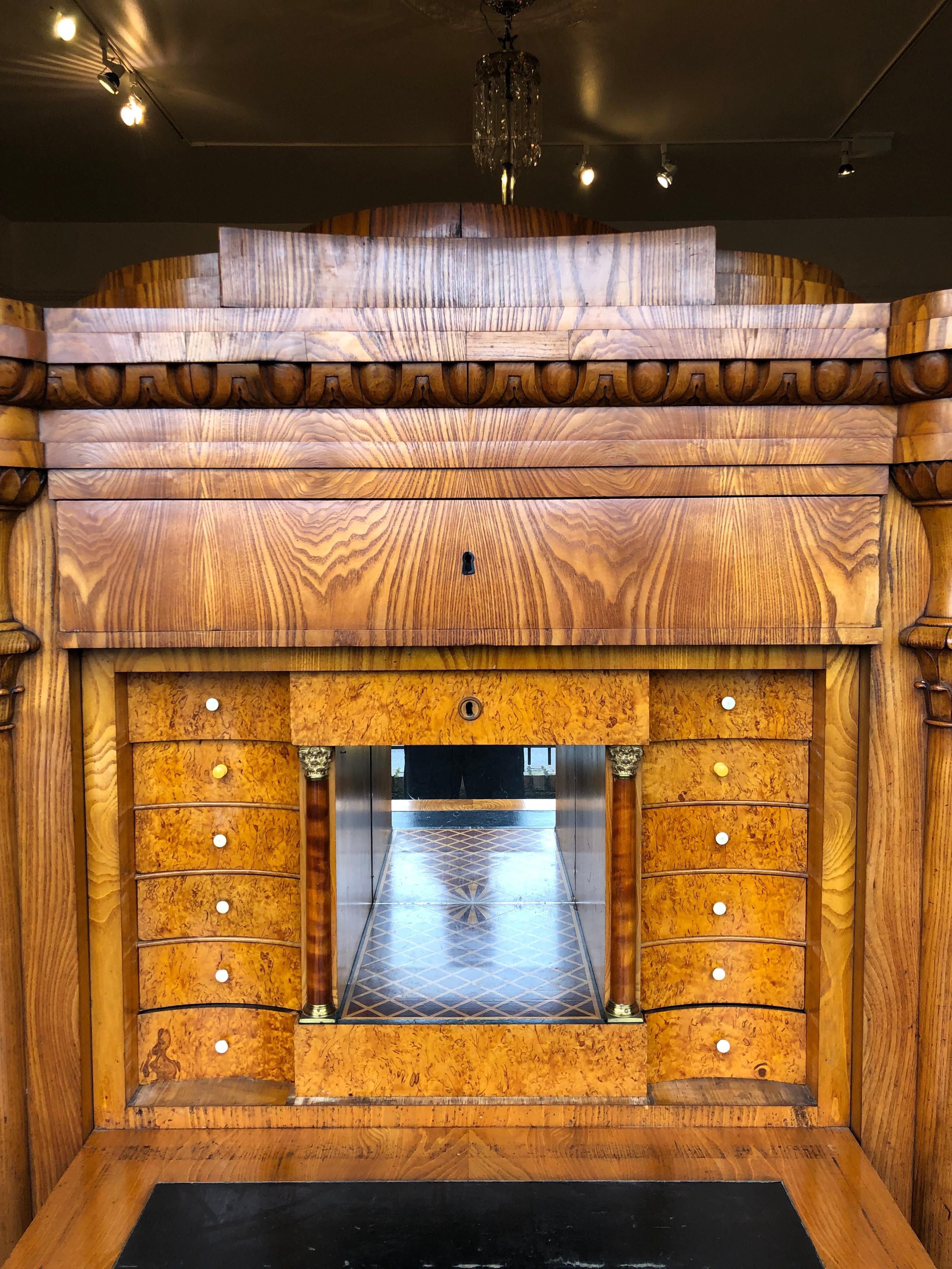 An impressive Biedermeier secretaire a abatant in Baltic walnut veneer.

Handsome substantial molding at the top. With bird's-eye veneer, inlaid and mirrored back interior. The drop down door is weighted and lowers easily. Can message for