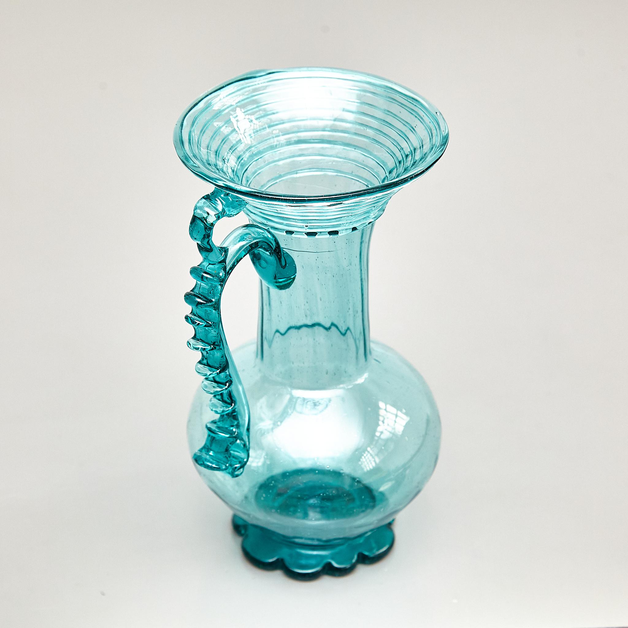 Elevate your decor with the exceptional beauty of this vintage blue blown glass vase from the early 20th century. Created by an unknown Spanish manufacturer circa 1940, this vase remains in its original condition, bearing minor wear that gracefully