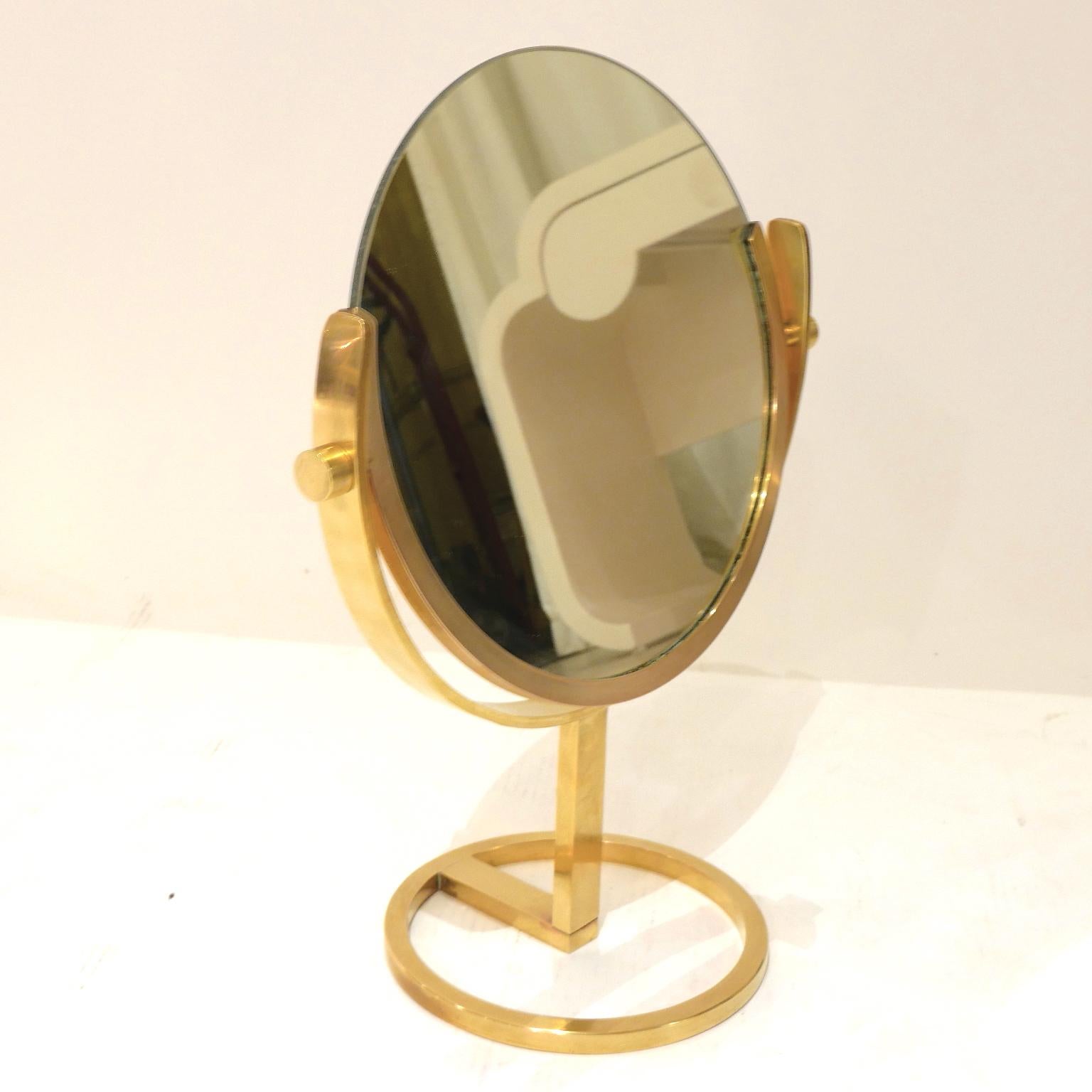 A heavy high quality brass vanity or table mirror with beautiful patina and sleek proportions that would look great on any dresser or vanity. 