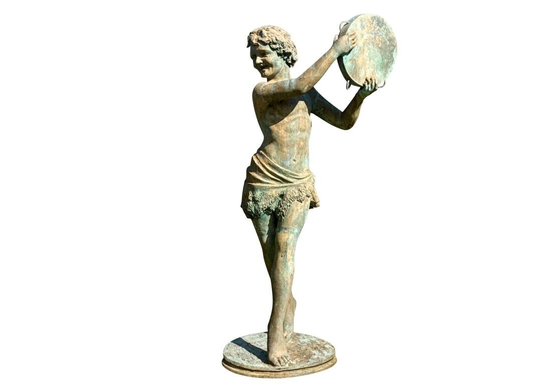 A large bronze garden statue depicting a smiling Neoclassical youth  wearing fleece  sash around the hip, posed walking over a circular base with a tambourine raised high.The bronze is mounted onto a later circular platform. 

Dimensions: 54” high
