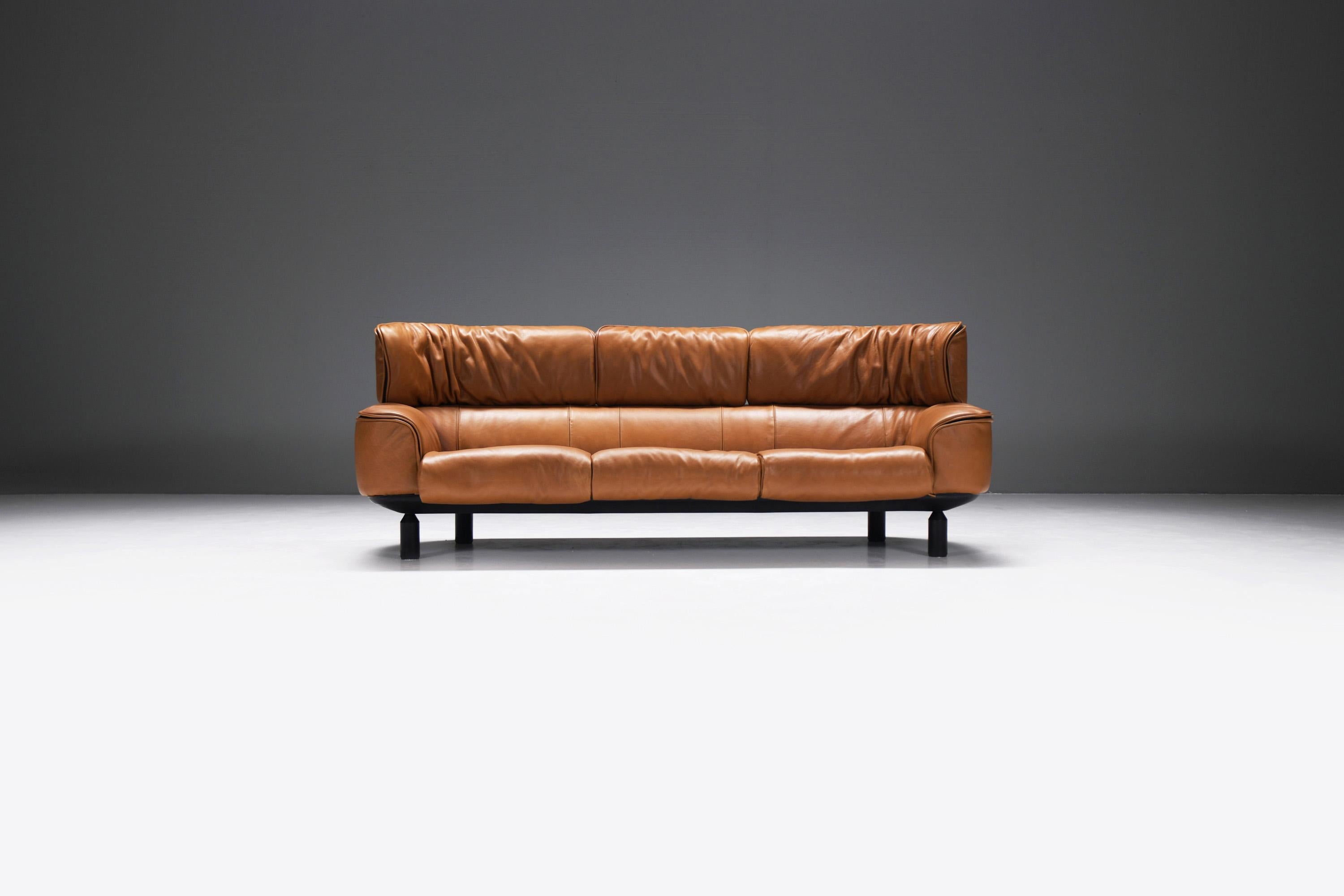Extremely stylish Bull sofa in a perfect cognac leather!  What a beauty!!  This sofa was only produced for 1 year (1987)
Designed by Gianfranco Frattini for CASSINA.

The Bull sofa  was Frattini's last project for Cassina. The collection included
