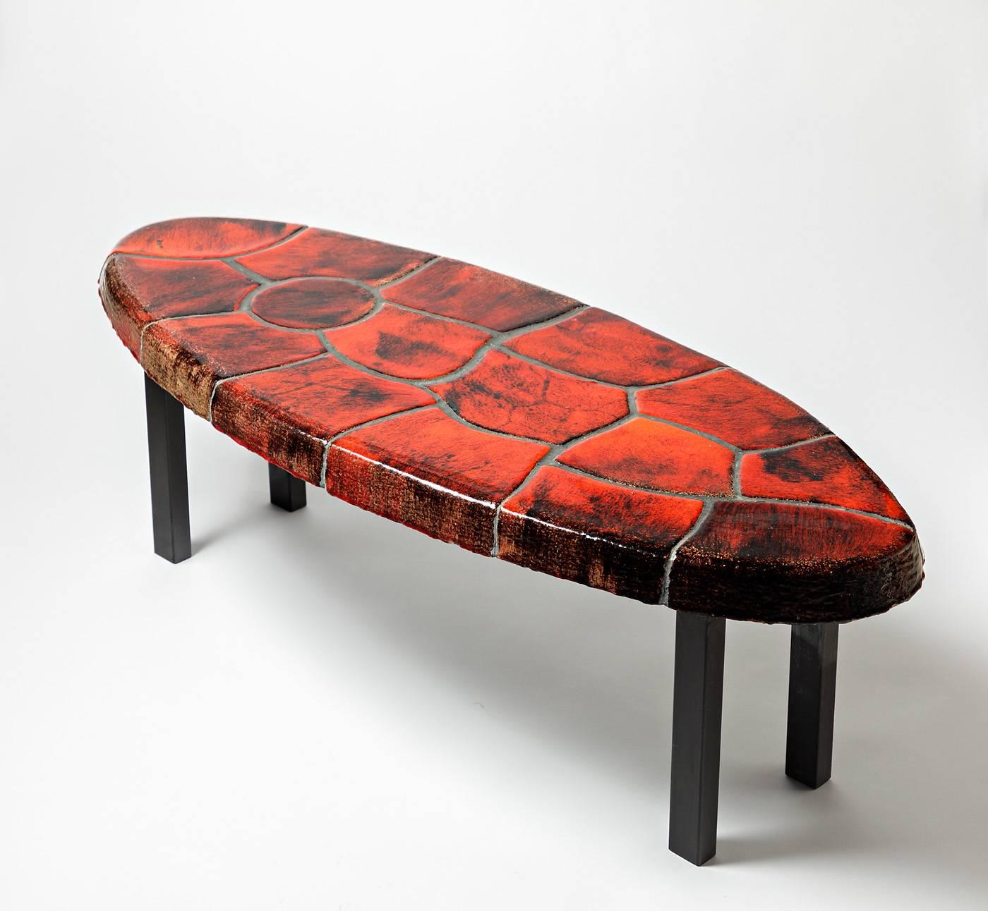 Exceptional low ceramic table

French production, circa 1970

Extraordinary red ceramic glaze and blackened metal legs

Dimensions: 36 x 110 x 43cm.
