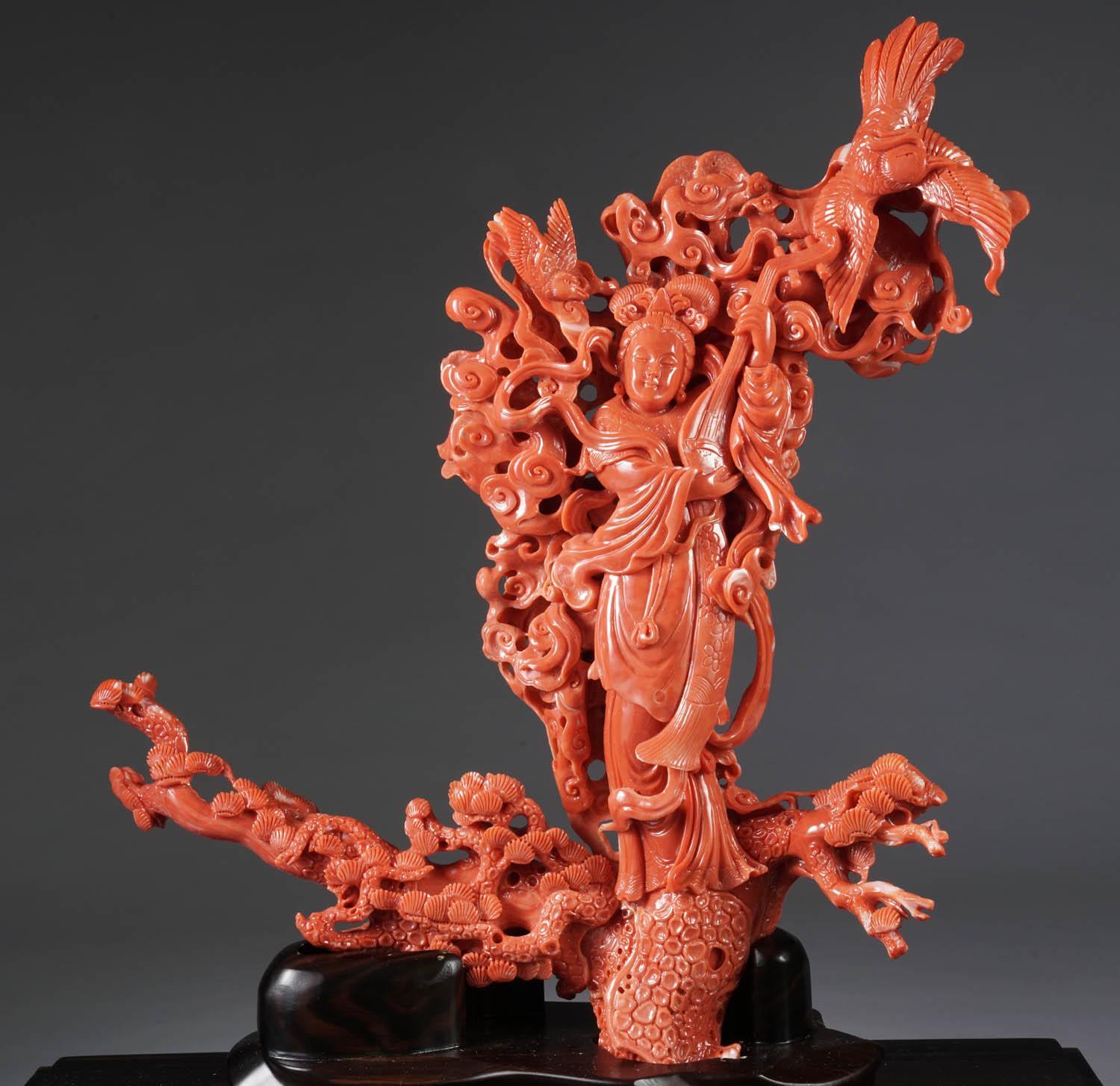 An exceptional Chinese carved coral figural group of a Guanyin, Kwan Yin with a Phoenix.

Very finely carved. In a custom made glass and wooden museum case. The coral has a nice, deep-red color.

Coral measures: 13