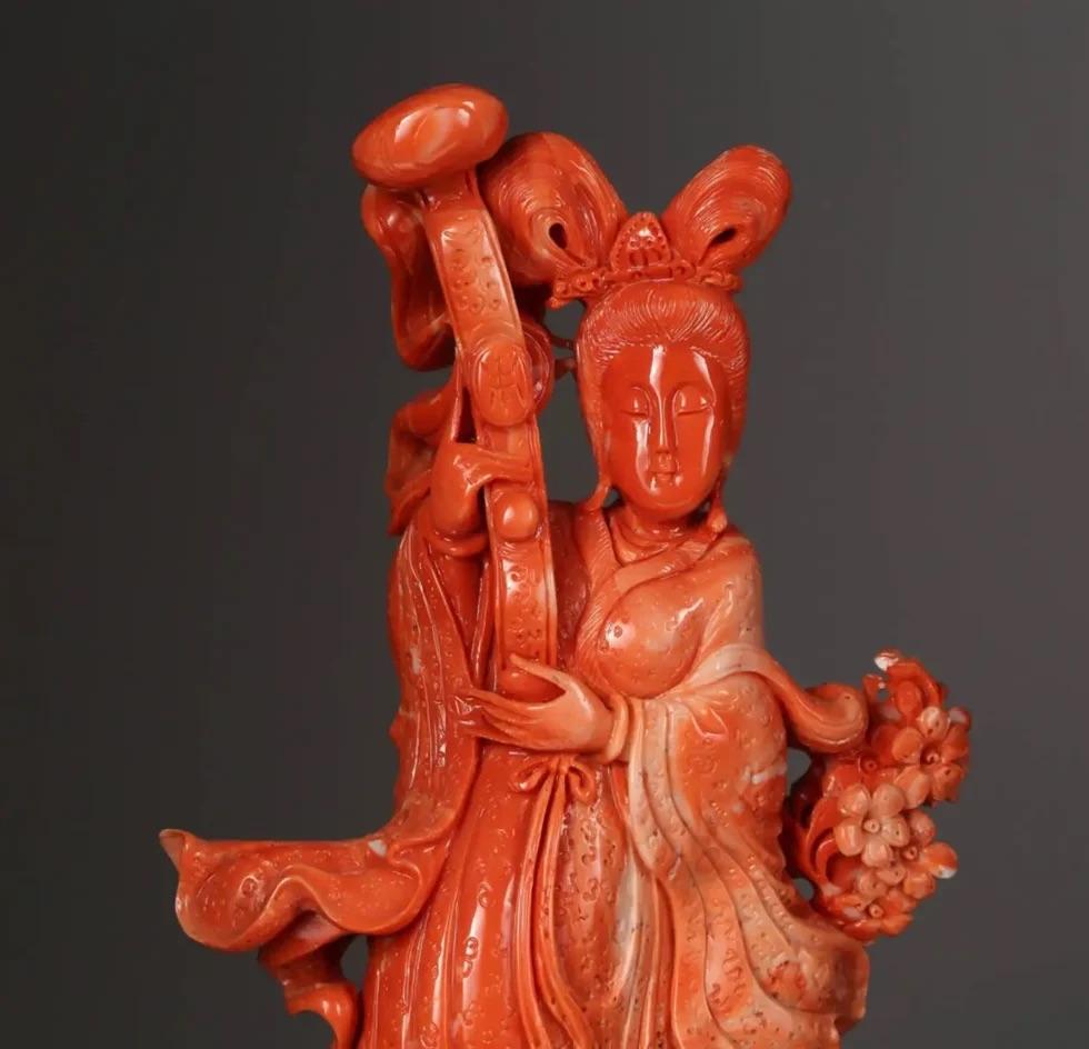 An exceptional Chinese carved coral figure of a Guanyin with deer.  

Very finely carved. With original wooden base.  

Measures: Coral: 12