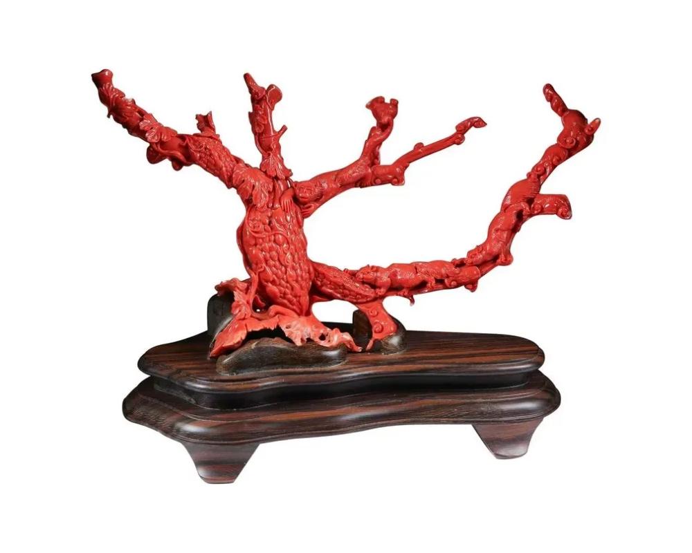 An exceptional Chinese carved coral tree branch with monkeys and squirrels, Qing dynasty. Very finely carved.

With original wooden base.

Coral: 6.5? high x 11.5? wide x 2? deep Stand length: 9 1/4 inches

Coral weight 354 grams.

Very good