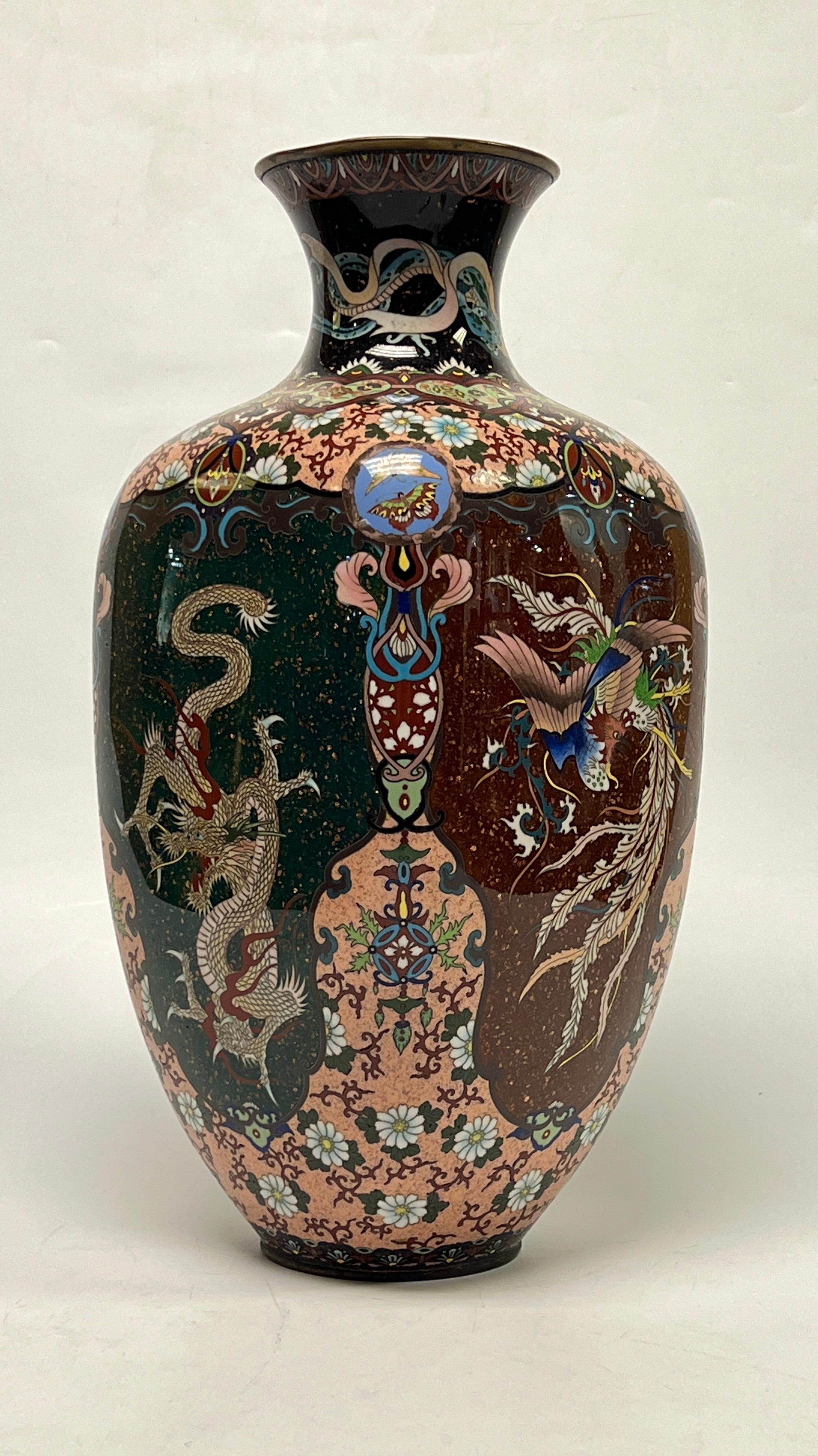 Beautiful antique (late 19th century) Asian cloisonne vase of rounded square form, 18 inches in height, featuring the figures of dragons on each of four sides.  In very good condition.