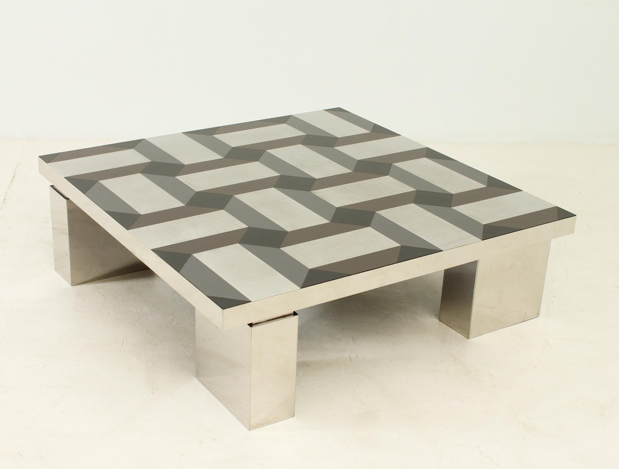 Exceptional coffee table with geometric pattern top, Italy 1970's. Chromed steel structure and top made of cut pieces of color laminate and steel forming a geometric pattern.