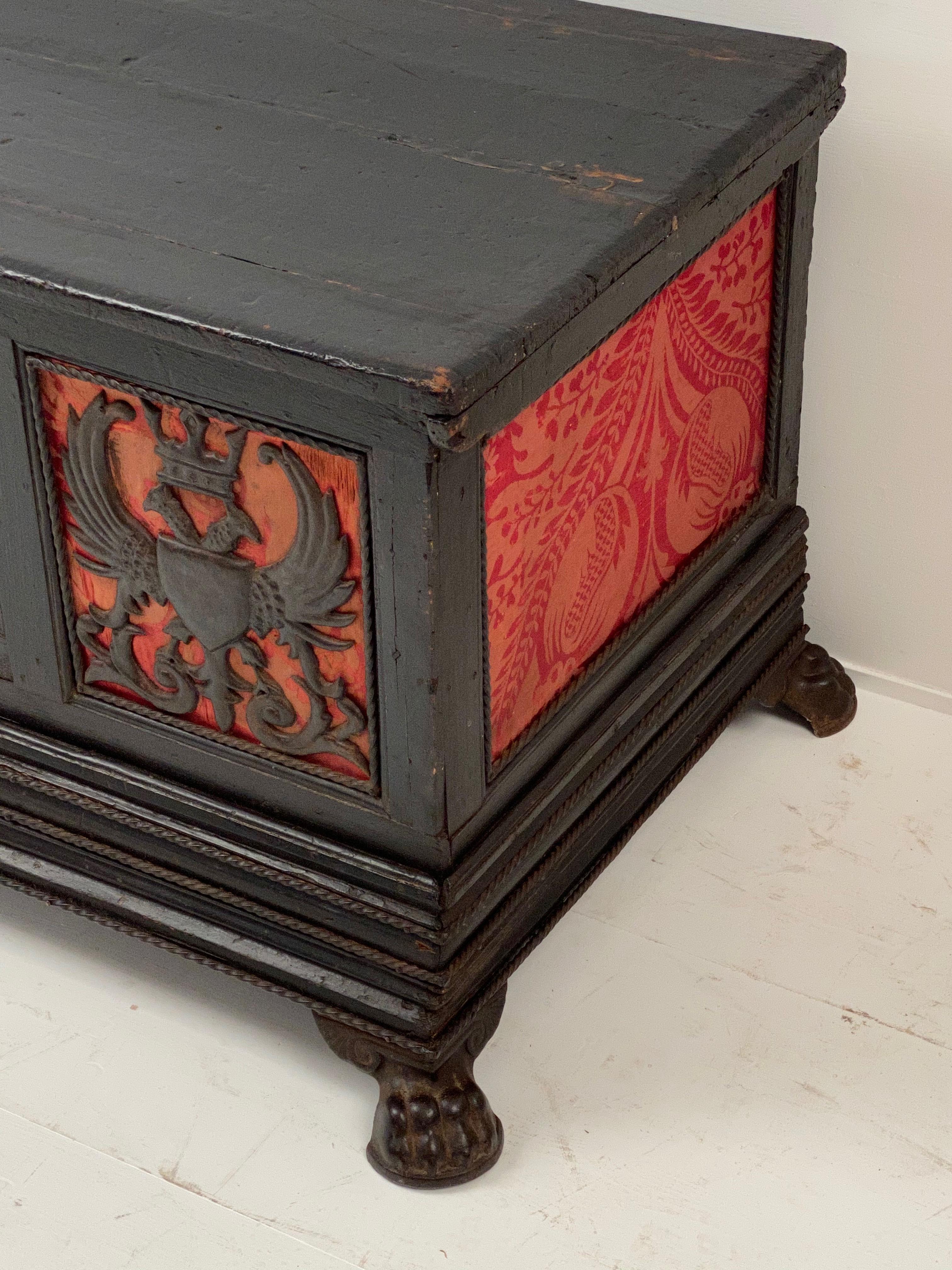 Elegant coffer in a dark fruitwood, exceptional combination of carved Royal Crowns an Eagles 
and a red textile, France, 18th century, elegant claw feed
there are also metal finishings
very old, good and powerful patina.