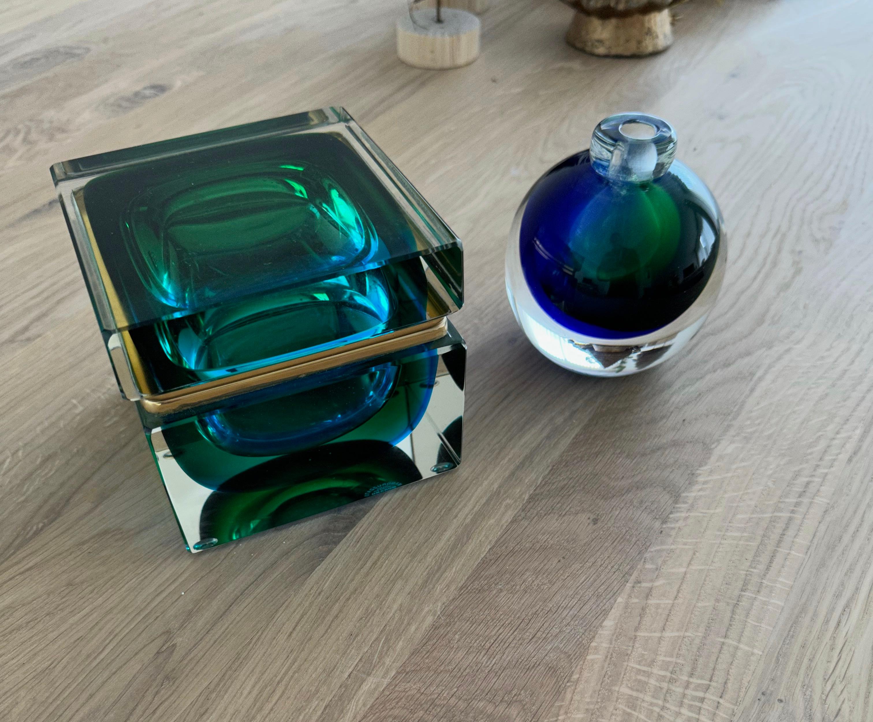 Mint condition and all handcrafted thick glass box, with a small vase made in Venice, Italy.

If you are looking for an exclusive and very stylish box for yourself or a loved one then this avantgardistic Italian work of beauty's from the 1970s