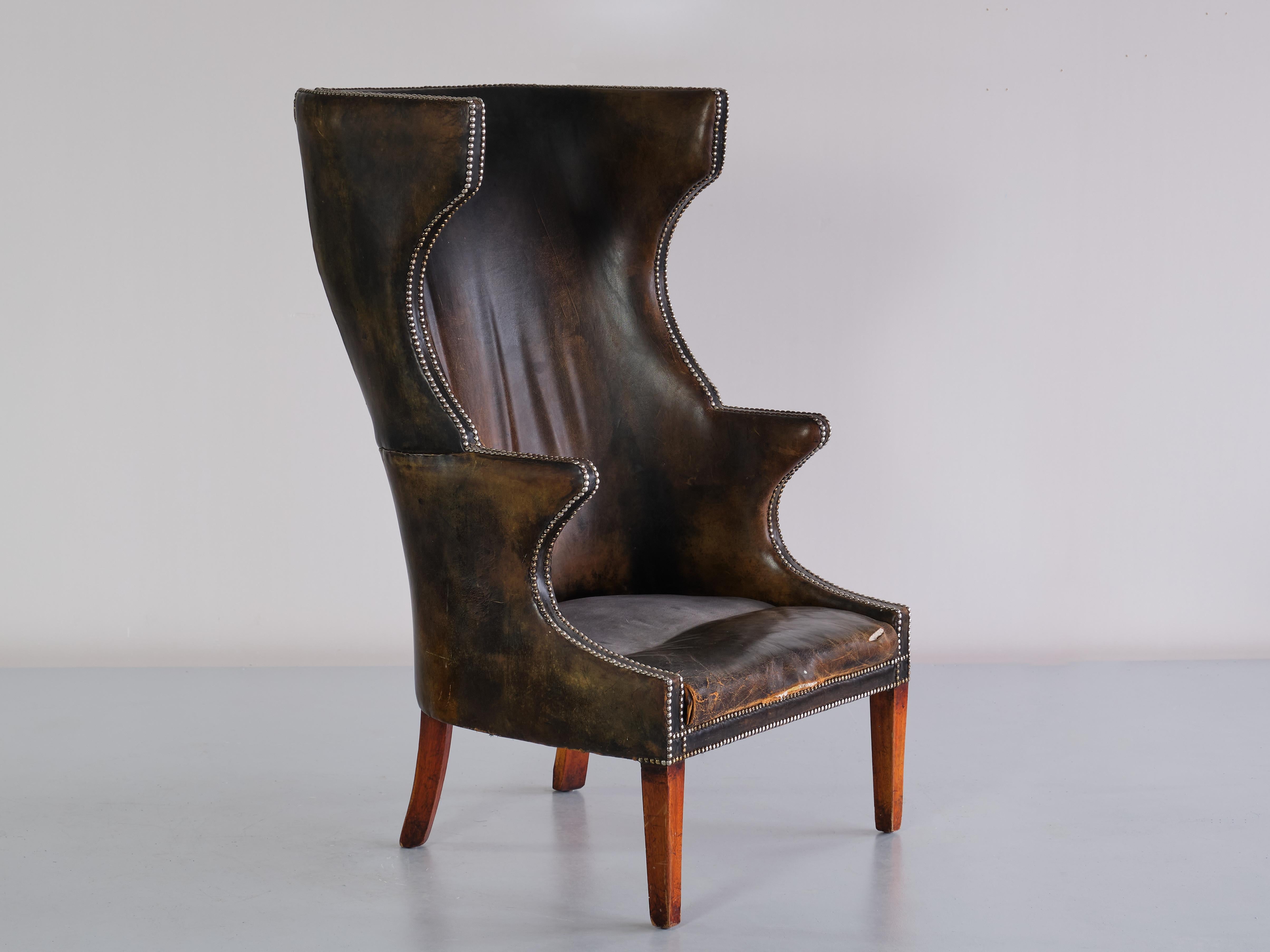 This exceptional wingback chair was produced by a Danish Cabinetmaker in the 1930s. The design is marked by its high back, distinct wings and curved armrests. The chair is a Danish modern interpretation of the classical British wing chair, with more
