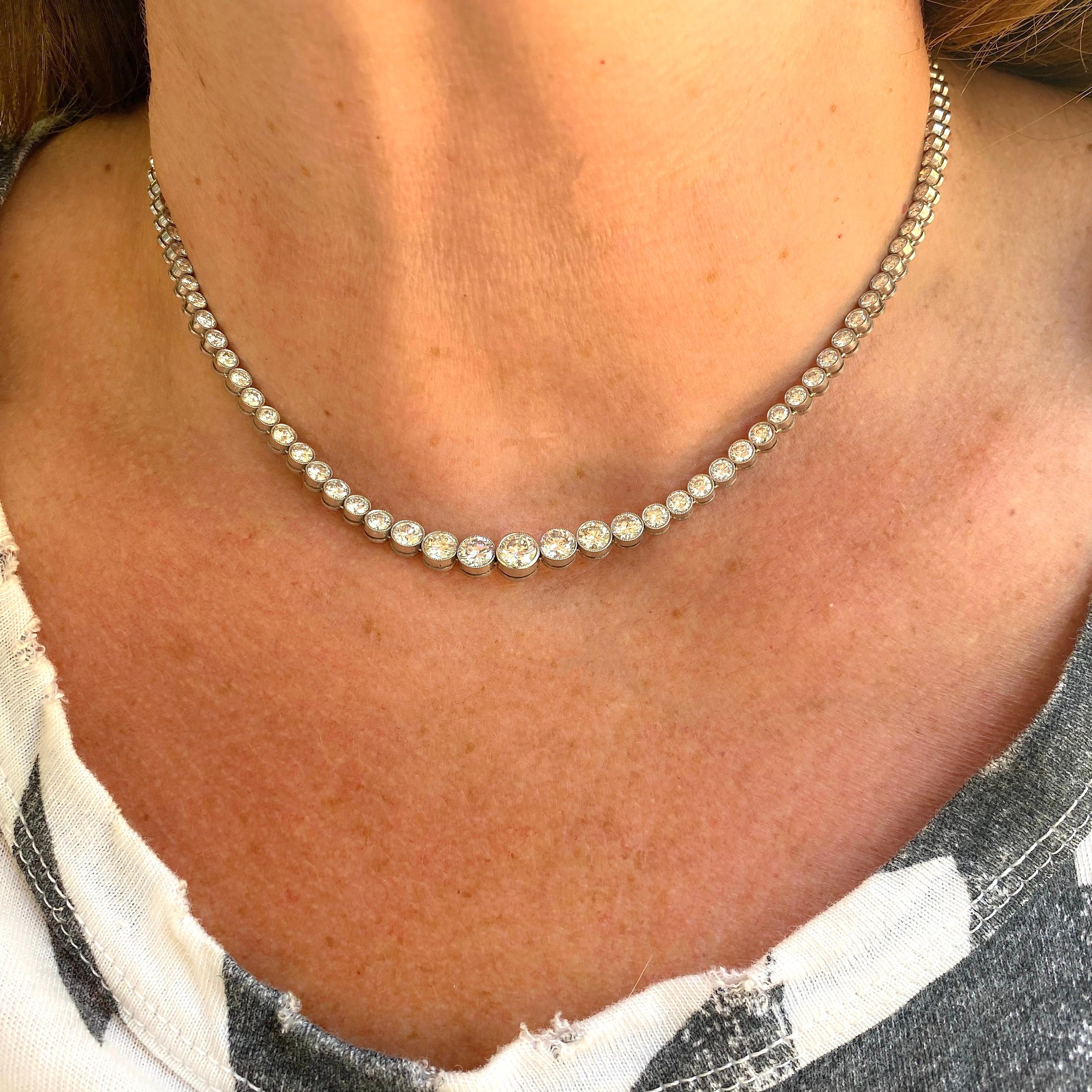 A must for every jewelry collector! This platinum rivière necklace is designed with 119 sparkling and bezel-set round brilliant-cut diamonds, weighing in total an estimated 12.00 carats, G-H/VS-SI. The necklace weighs 28.8 grams and measures 16