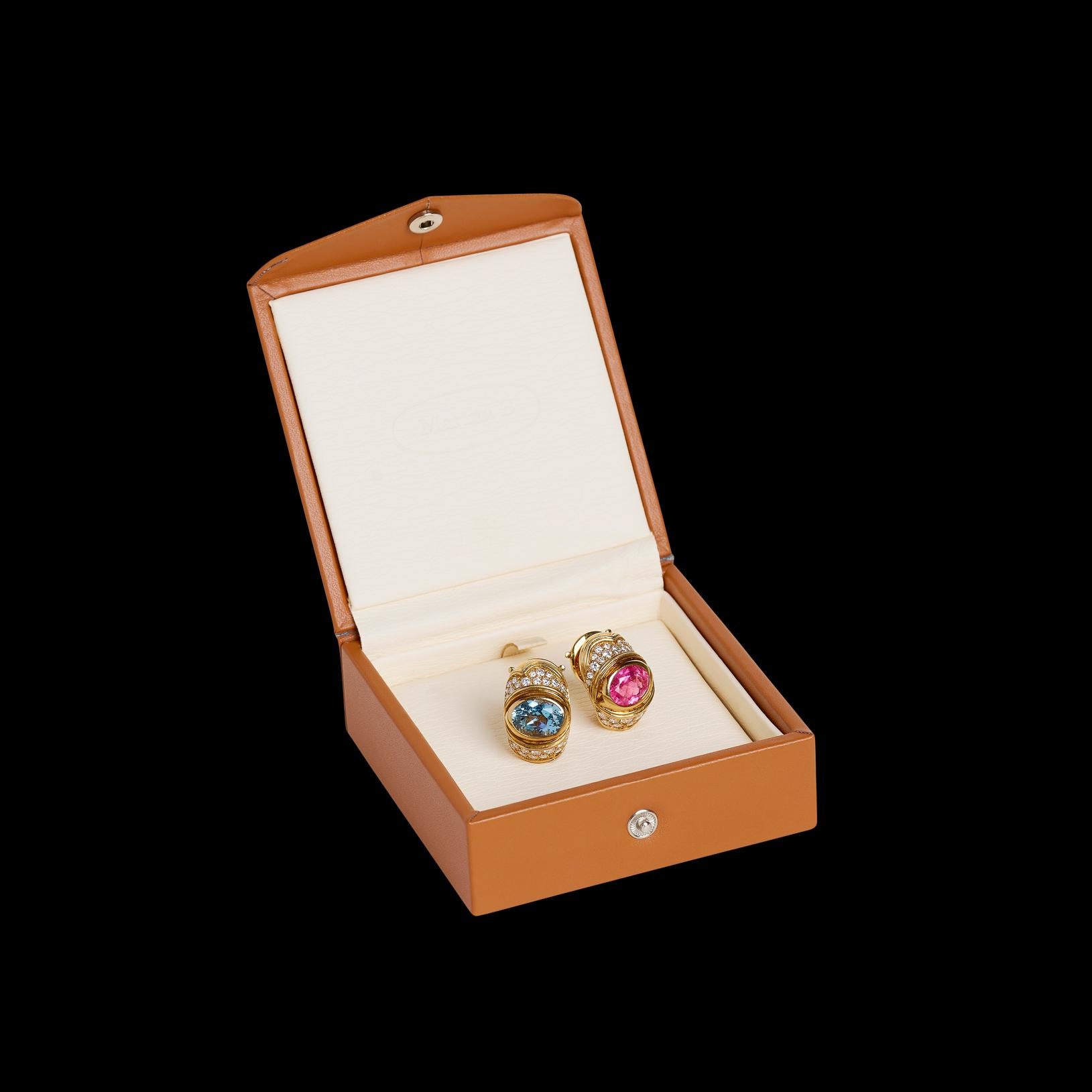 The pop of color that every collection deserves! From famed designer Marina Bulgari come these 18 karat yellow gold earrings featuring a 3.30 carat pink tourmaline and a 3.30 carat blue topaz, accented by 1.58 carats of fine white diamonds. The
