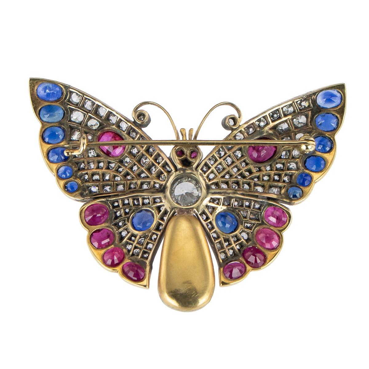 Exceptional 20th Century gem set in 18k two-colour gold brooch, designed as a butterfly, wings set with oval-shaped sapphires, oval-shaped and cabochon rubies and rose-cut diamonds, body of natural saltwater pearl, gold unmarked (tested 18k gold),