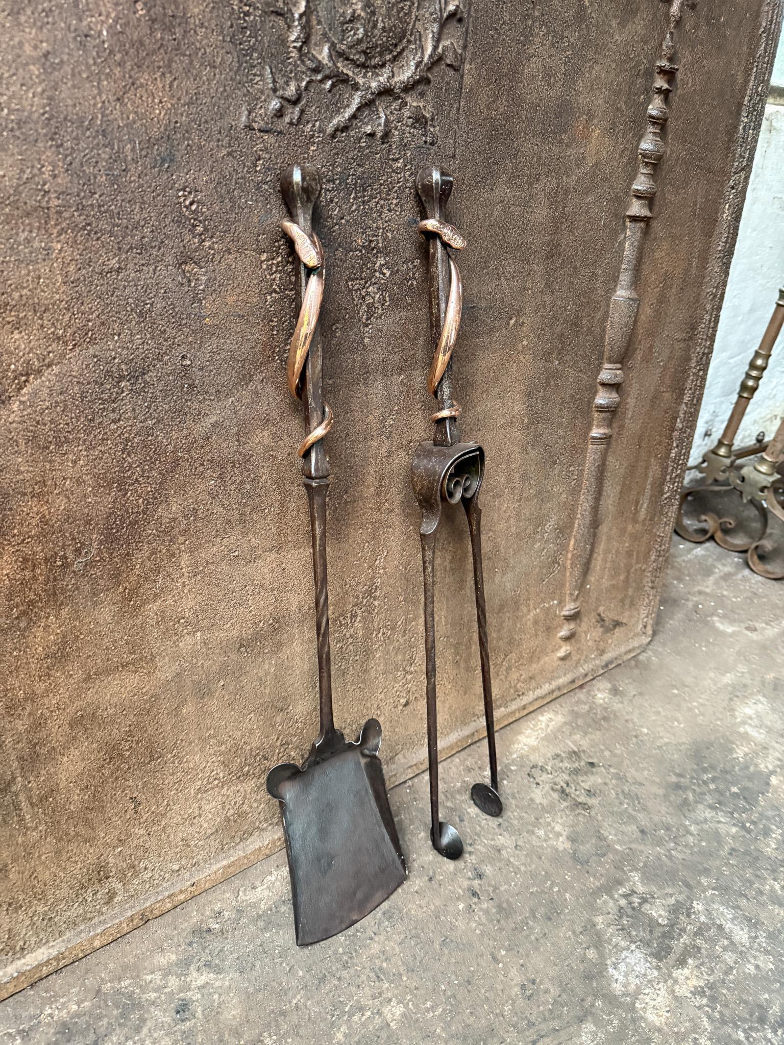 Dutch Art Nouveau Style fireplace tool set, companion set made of wrought iron and polished copper. The condition is good.