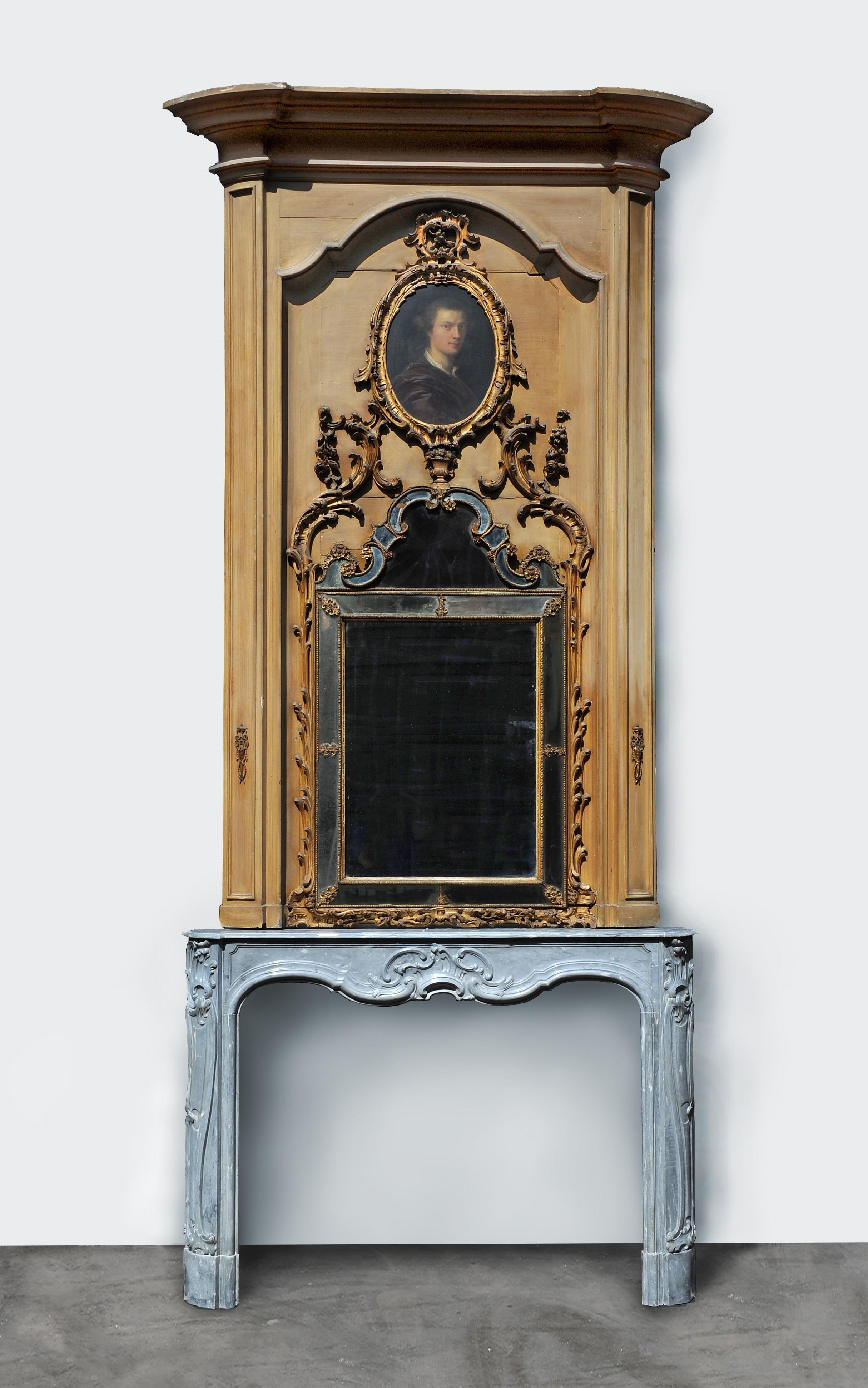 We are very pleased to offer this exceptional and original combination of a beautiful grey marble fireplace with its original trumeau in the Rococo manner.

This 18th Century mantel is created from the nicest Italian grey Bardiglio marble with