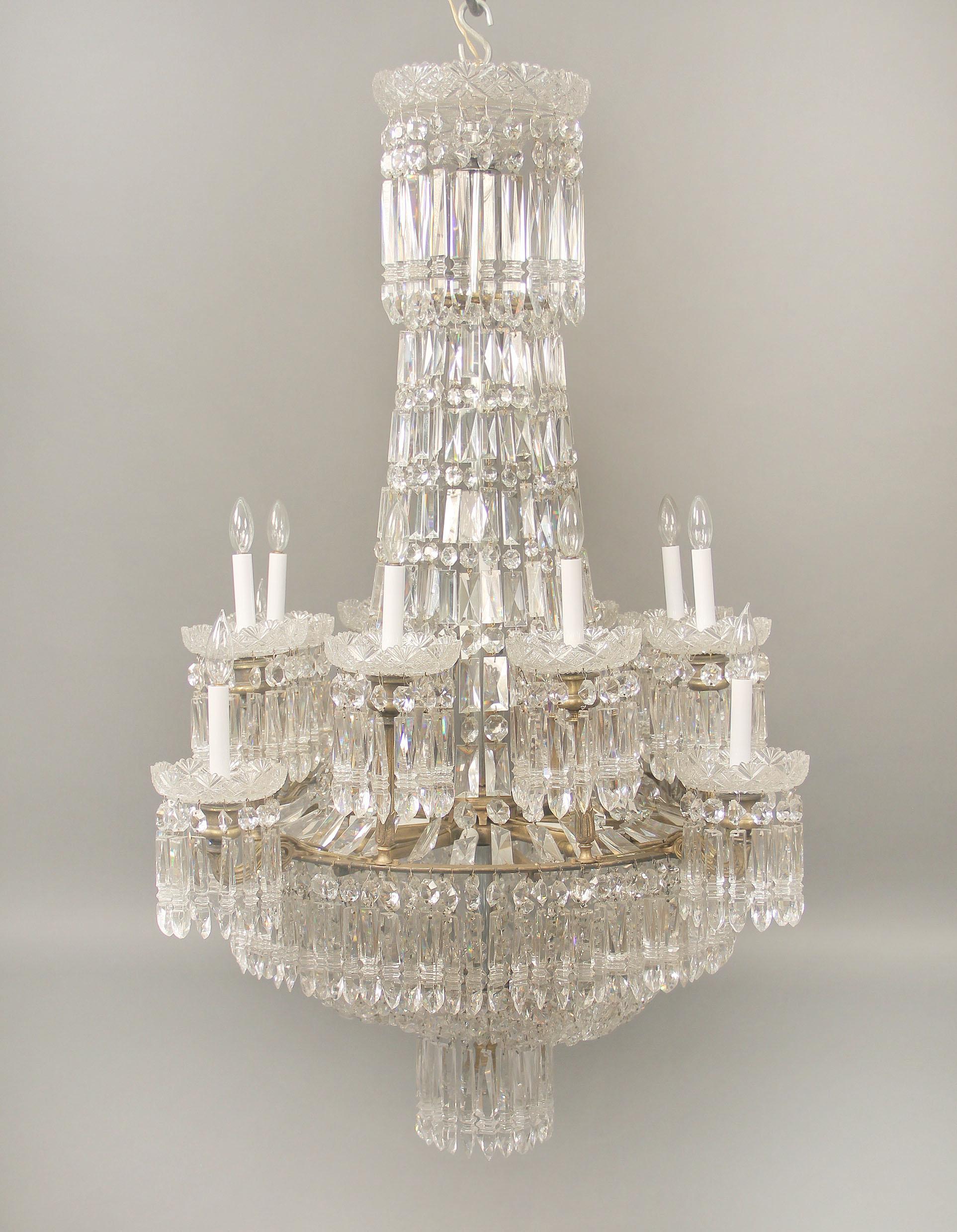 An exceptional early 19th century gilt bronze and Waterford crystal eighteen light chandelier

An etched crown above a crystal string body leading to a beaded basket with drop crystals, each of the twelve tiered perimeter lights with top quality cut