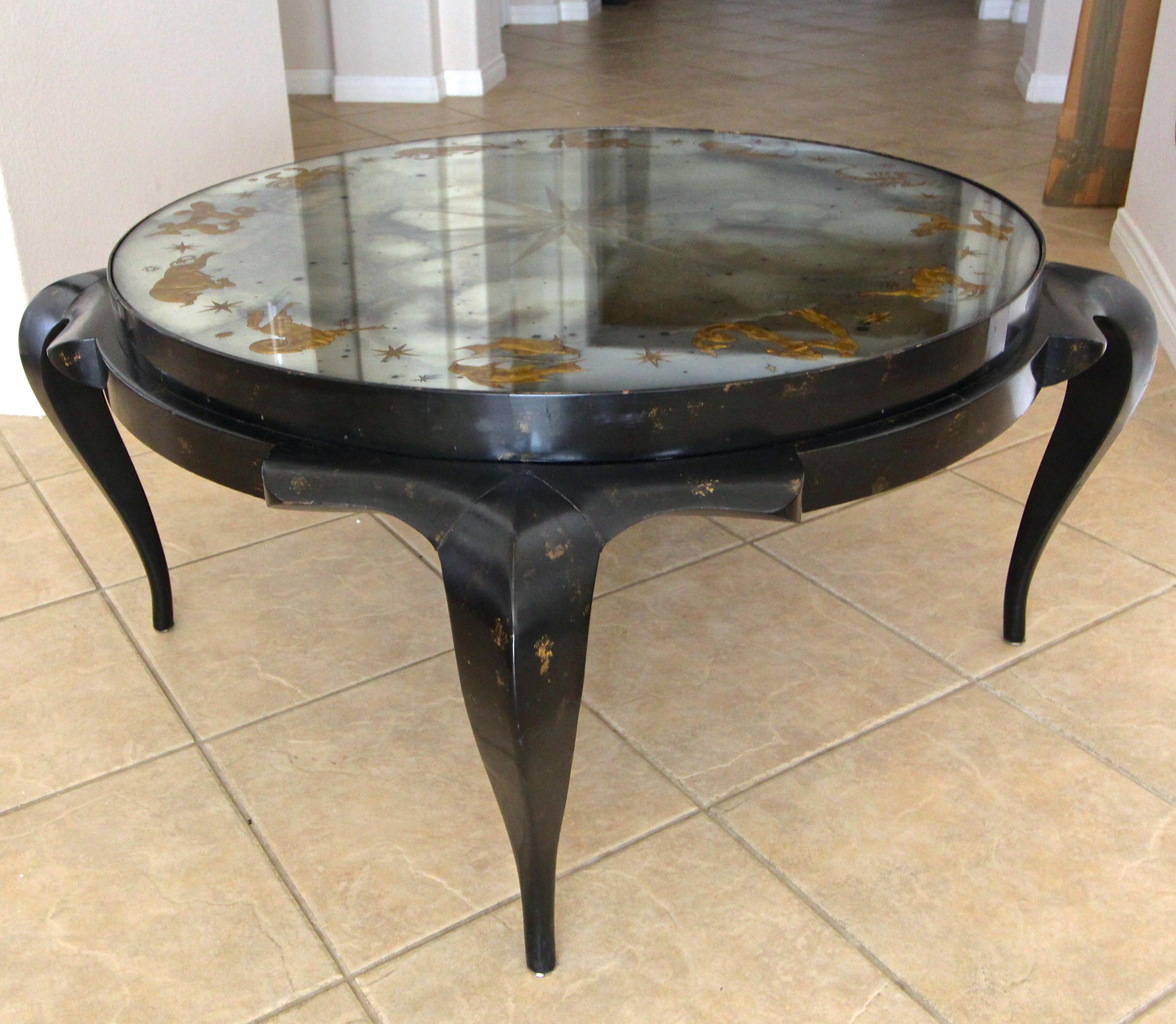 One of a kind Art Deco cocktail or coffee table by David Harriton for Harriton Carved Glass of New York, circa 1940. The smoked mirror top features a beautiful gold églomisé Zodiac pattern reverse carved into the glass by sandblasting, a process