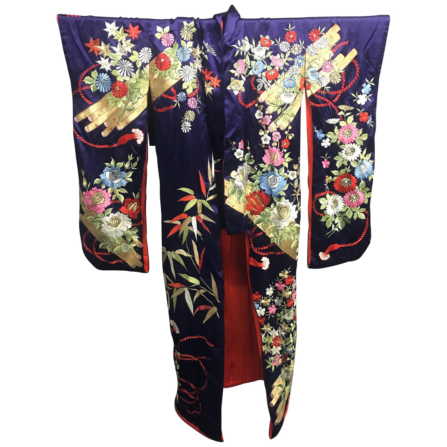 A vintage Uchikake Wedding Kimono/Robe for ceremonial occasion, circa 1940s in an Oriental Art Deco style. Deep violet/purple silk background with elaborate and intricate embroidery in colored, sliver and gold threads. The front and the back of the