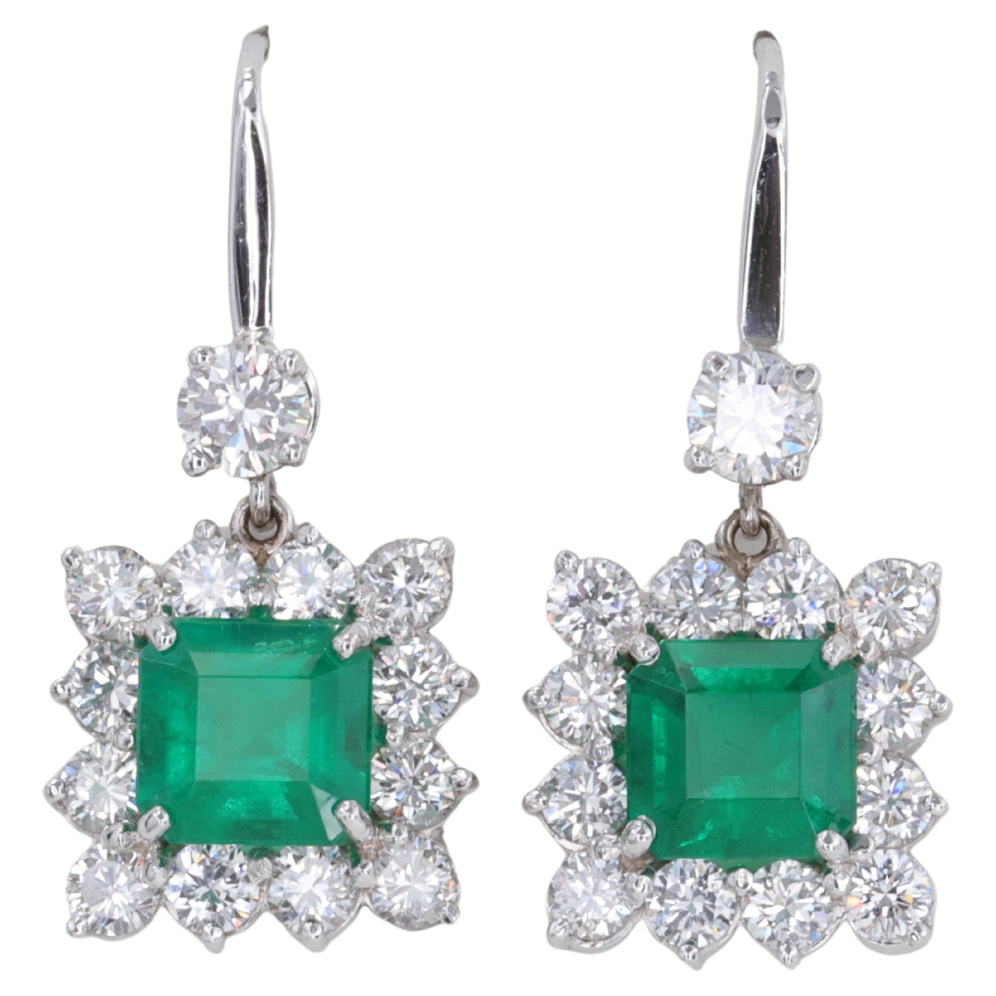 Exceptional Emerald and Diamond Halo Dangle Earrings Set in 18 Karat White Gold For Sale