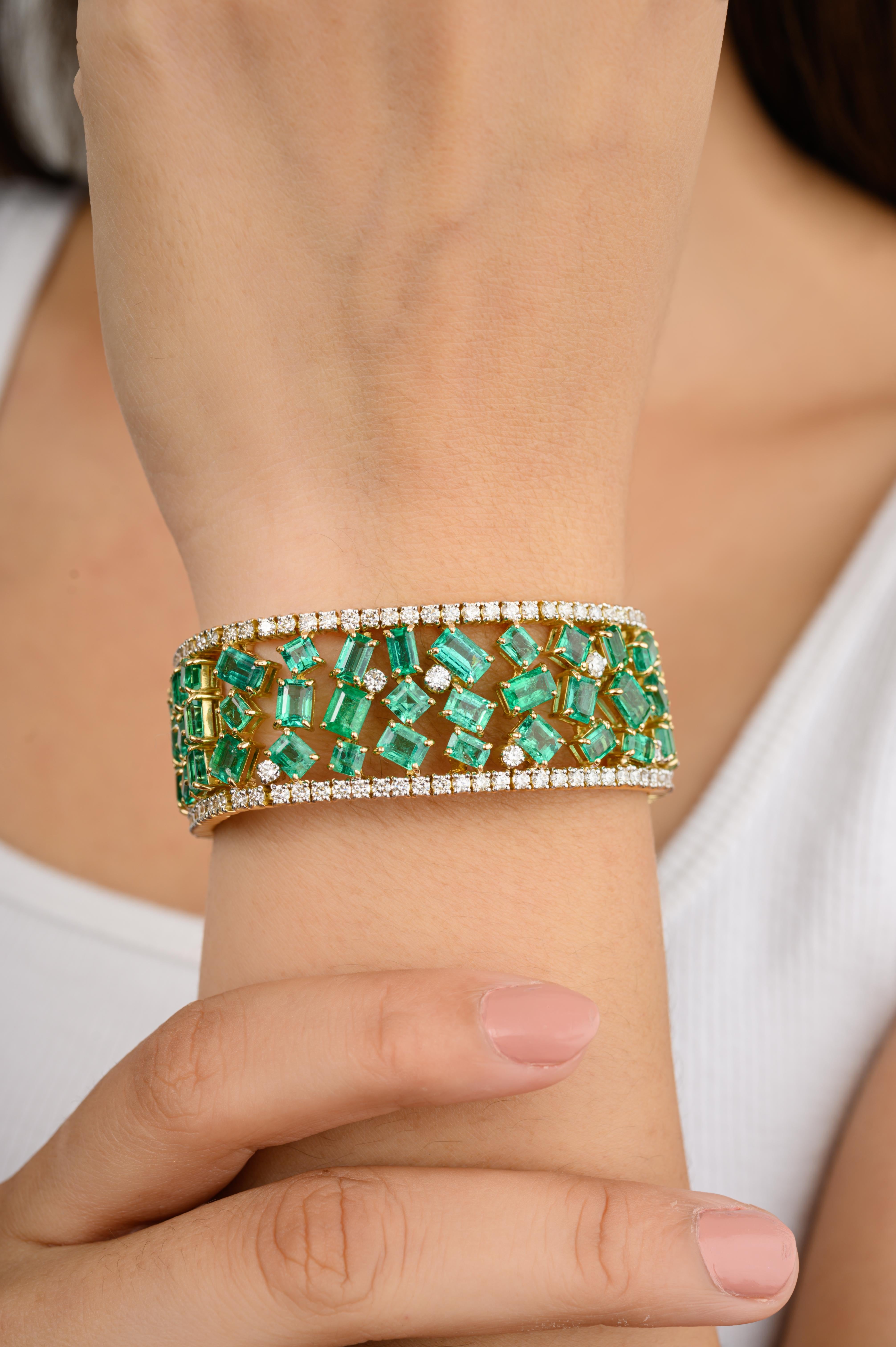 This Exceptional Emerald Diamond Wide Cocktail Bracelet in 18K gold showcases endlessly sparkling natural emerald, weighing 28.35 carats and diamonds of 6.17 carats. It measures 7.5 inches long in length. 
Emerald enhances intellectual capacity of