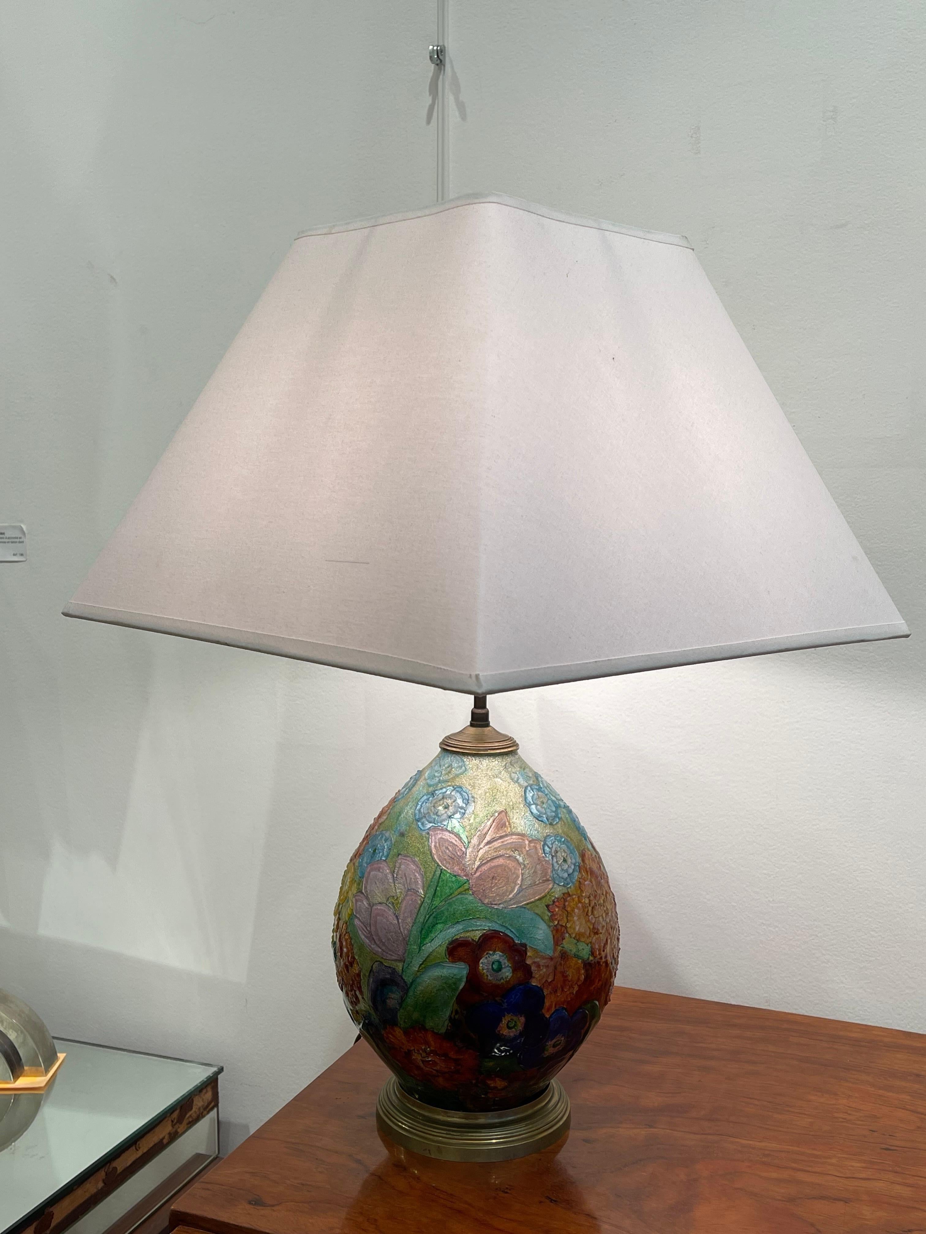 Exceptional table lamp by Camille Fauré(1874-1956) whose workshop was in Limoges (France). It has the shape of an egg made of copper fully covered with polychromic and translucent enamel representing flowers. The quality of the enamel is outstanding