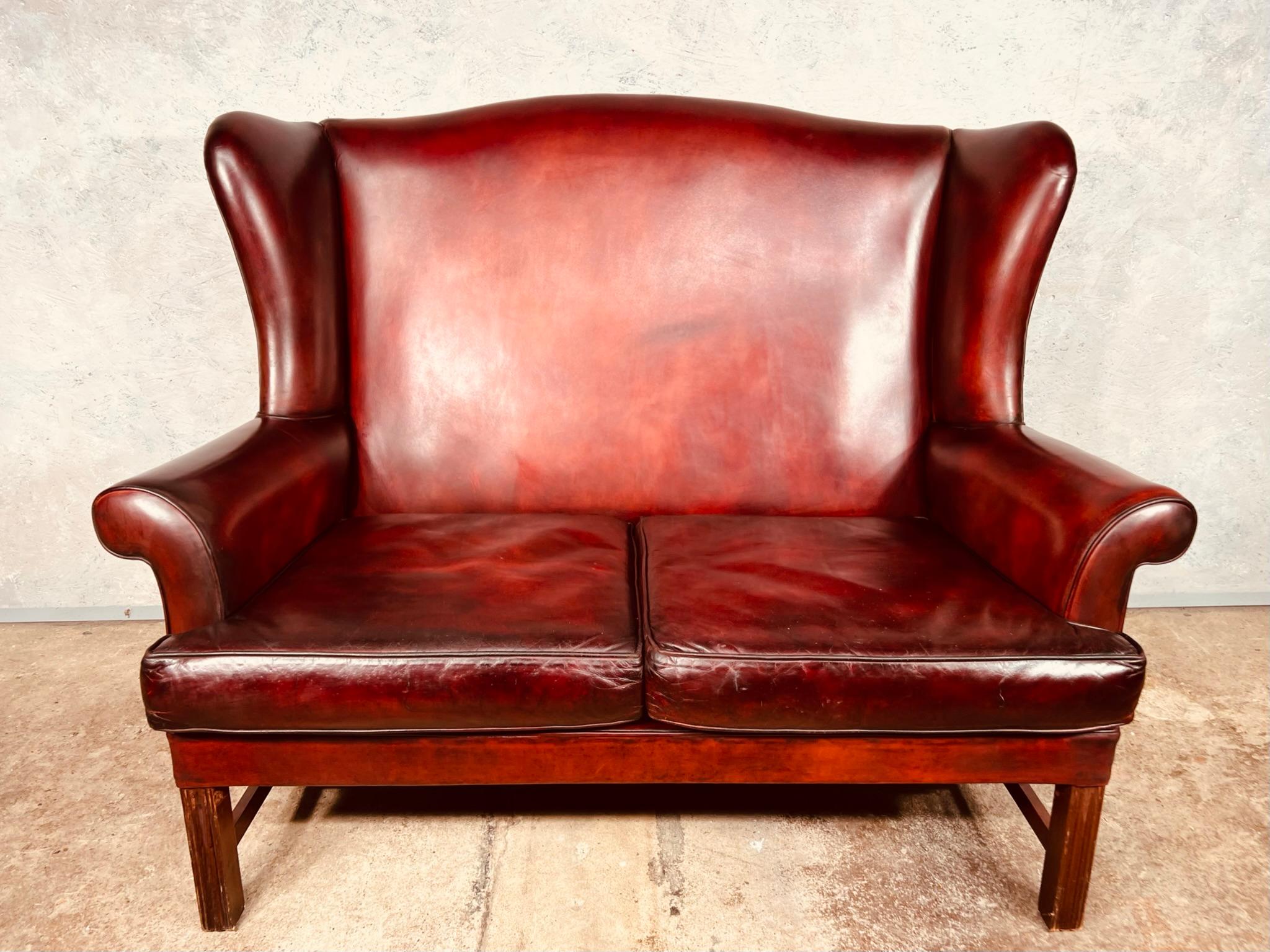 A Great quality midcentury leather Georgian Style sofa, lovely neat size, it stands beautifully on solid reeded mahogany legs.

In excellent condition, the leather is a beautiful Hand dyed Deep Red with a lovely finish and a great patina.

 