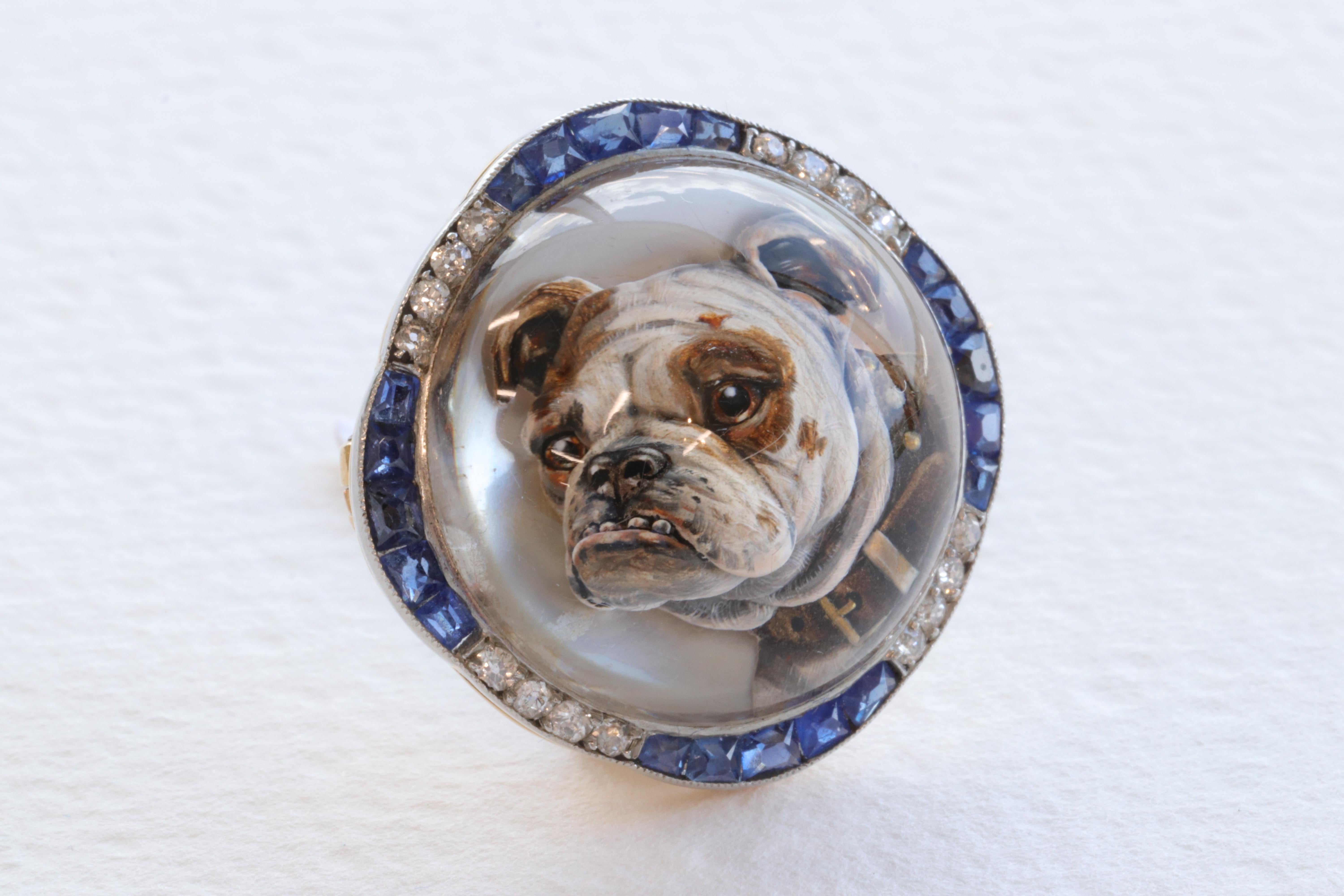 This exceptional Essex crystal brooch features a hyper realistic reverse intaglio of an English Bulldog hand carved into rock crystal and hand painted to perfection. The brooch is crafted of Platinum and 18 Karat Yellow Gold and set with old mine /