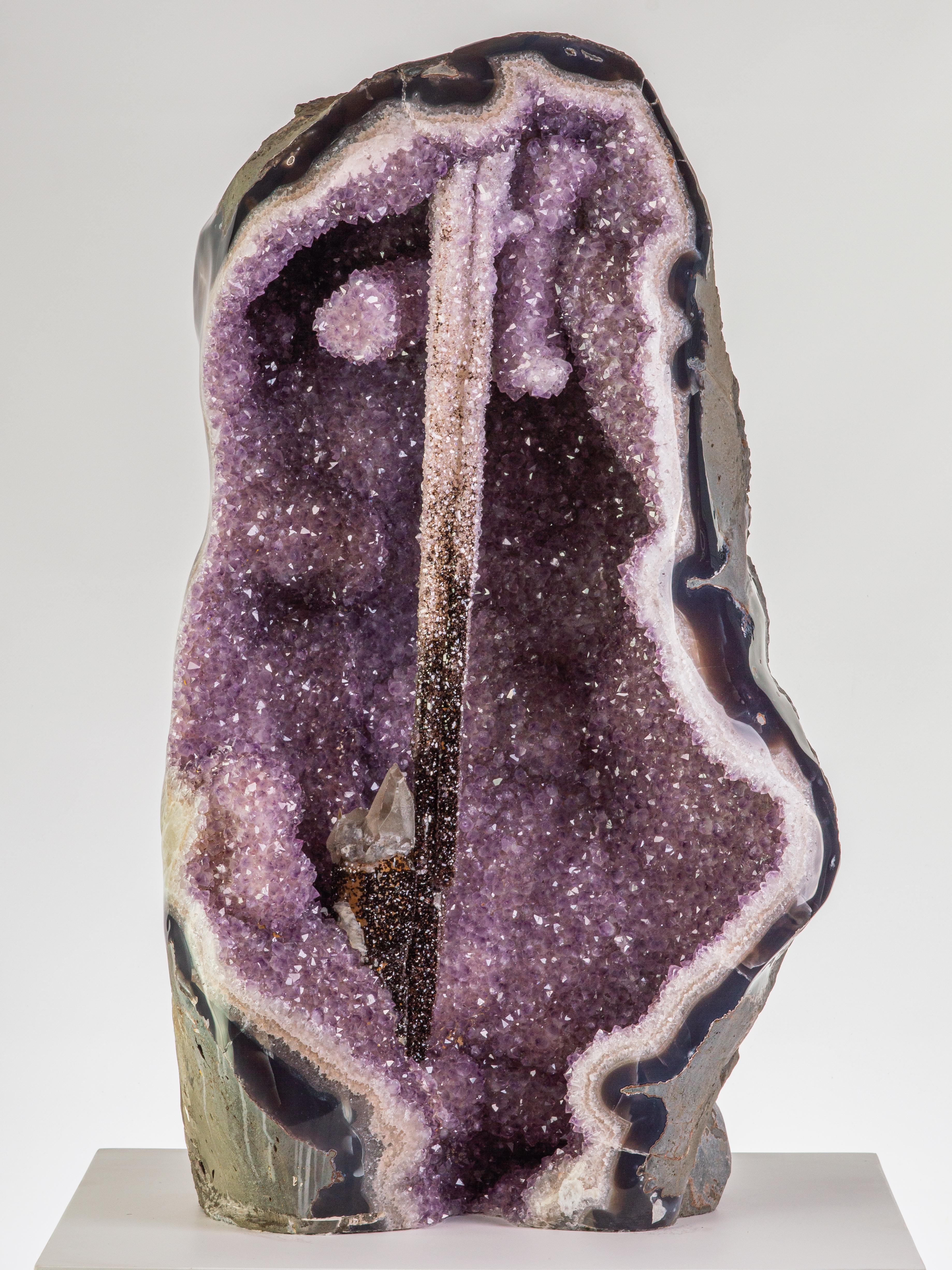 With its extremely unusual central amethyst epimorph after calcite, this natural
wonder evokes images of the legendary sword, Excalibur, magically fixed in
the stone. Elsewhere we see quartz-frosted calcite, goethite and amethystine
quartz. An