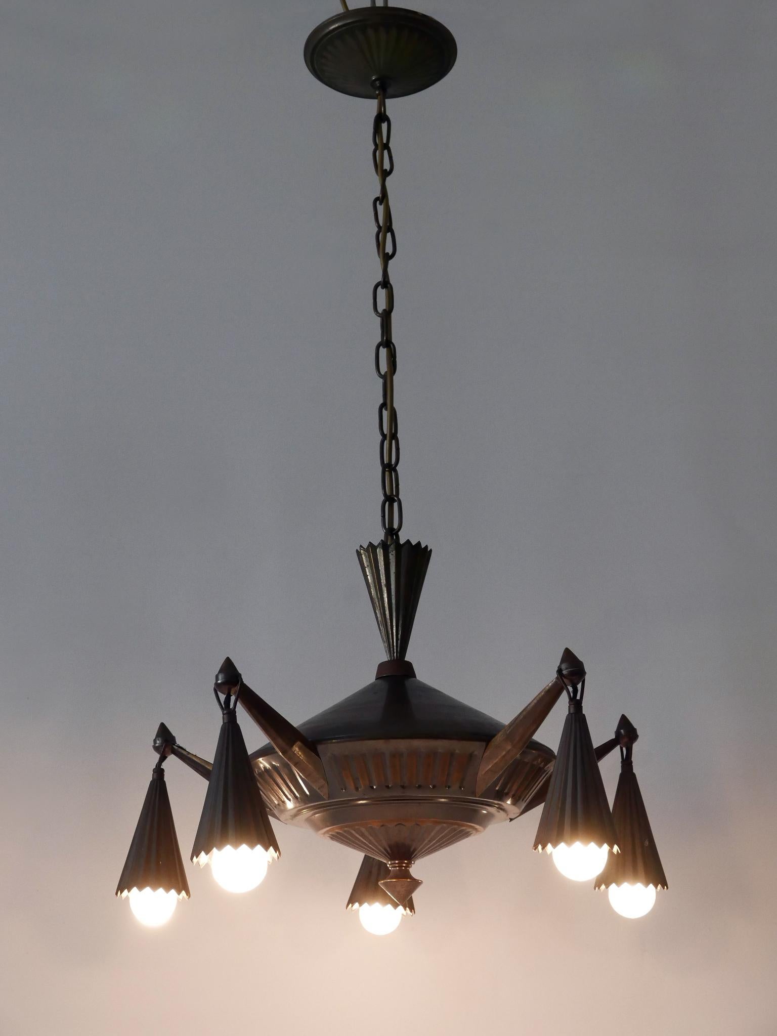 Extremely rare and decorative five-flamed Cubist Art Deco brass chandelier or pendant lamp. Designed and manufactured probably in Germany, 1920s. In the Style of Dagobert Peche.

Executed in brass, the lamp comes with 5 x E27 / E26 Edison screw fit