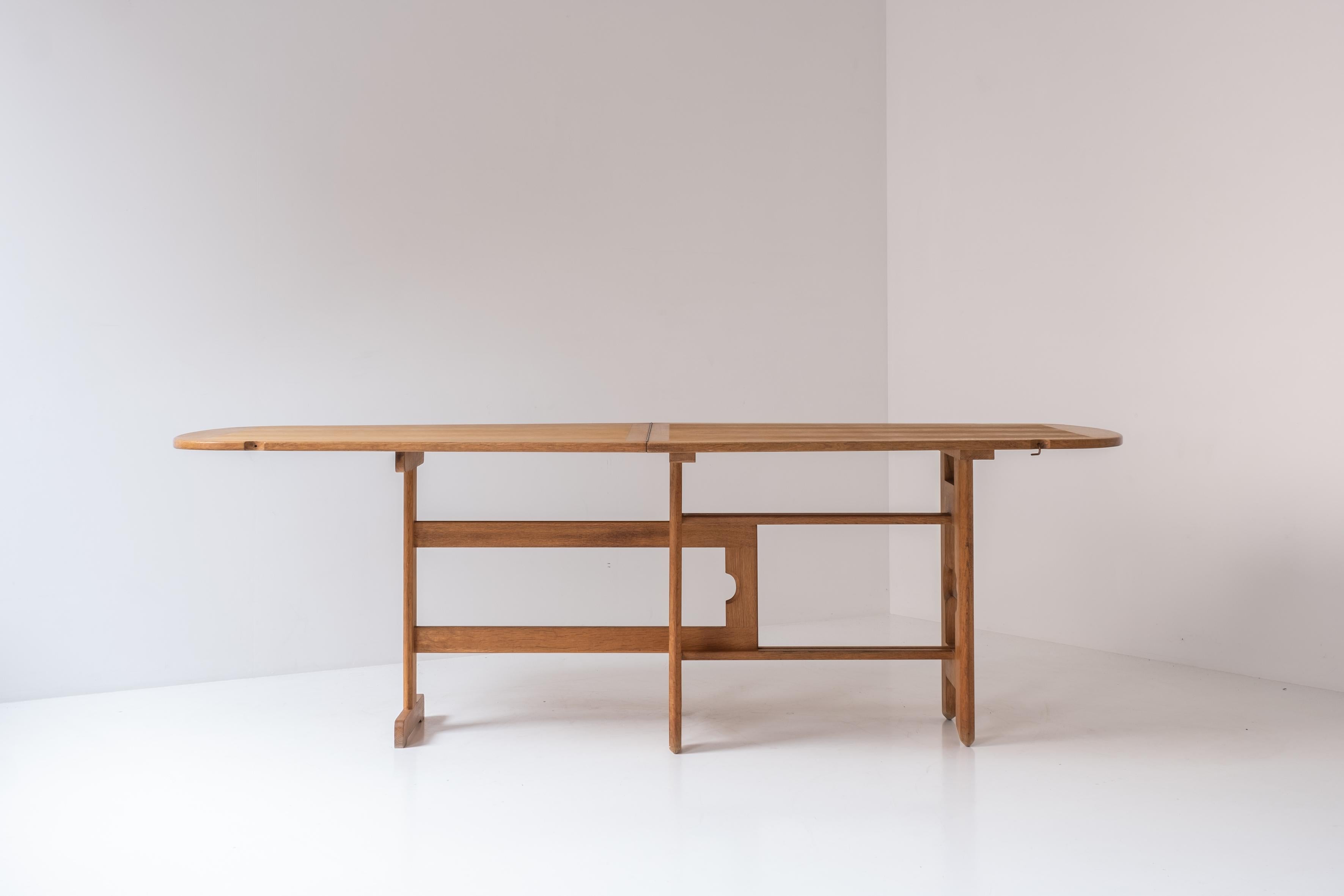Exceptional folding dining table by Guillerme et Chambron, France 1970s. This architectural Masterpiece features a solid oak construction, exceptional base, and folding table top that can expand as needed. In overall very well presented and original