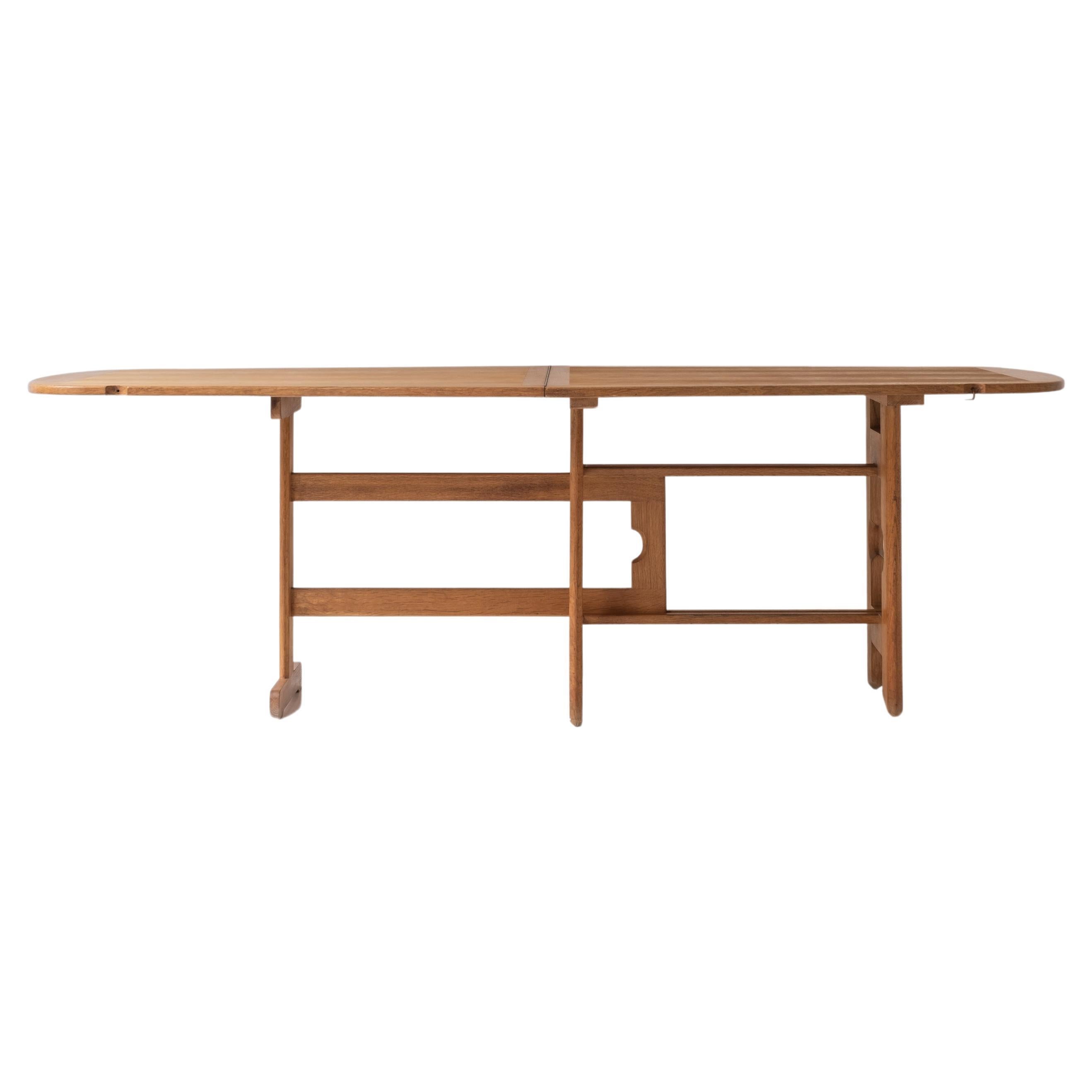 Exceptional folding dining table by Guillerme et Chambron, France 1970s. For Sale